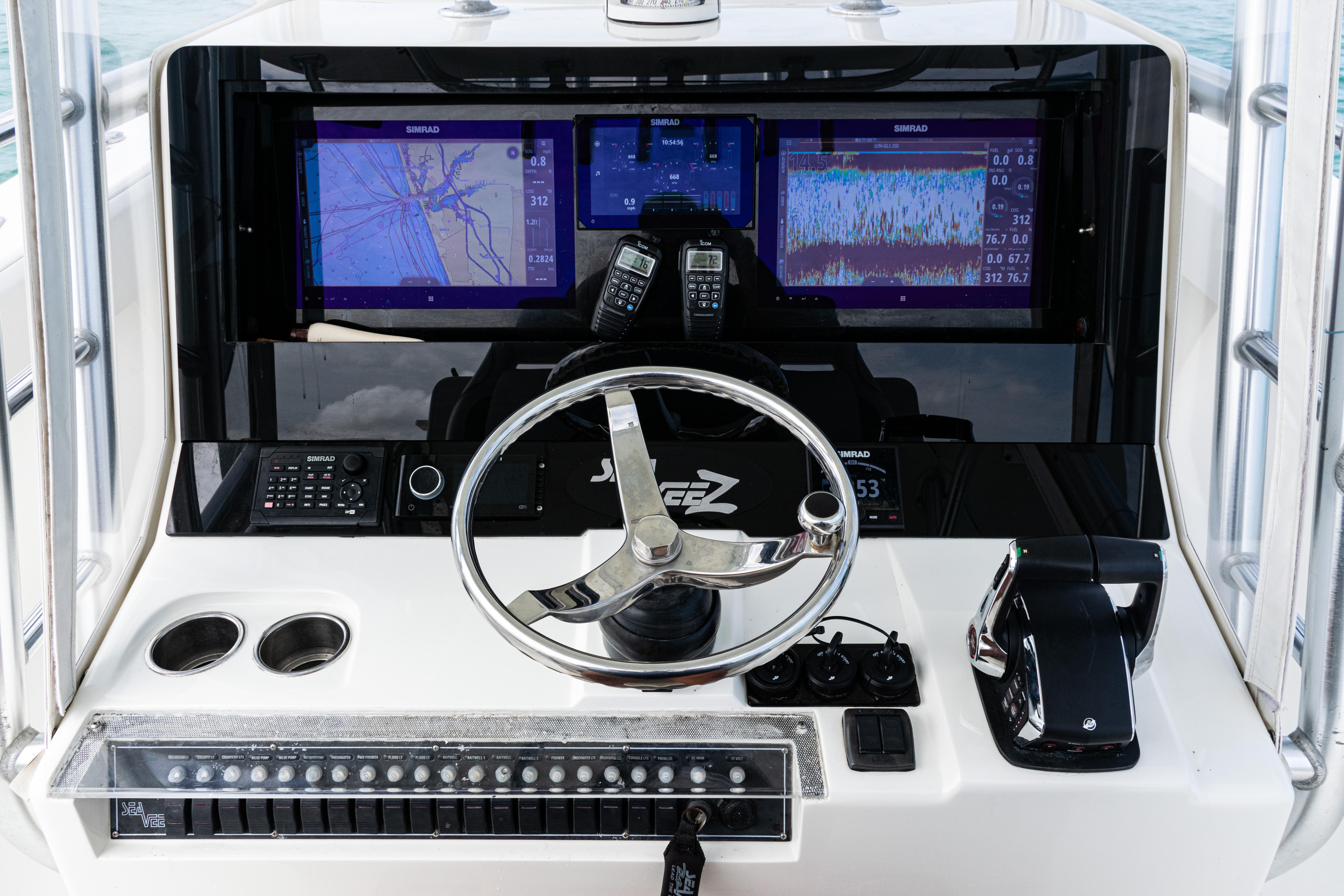 SeaVee-390Z 2015 -FL-US-Control panel of a 2015 SeaVee 390Z boat with navigation screens and steering wheel.-9741010 | Thumbnail
