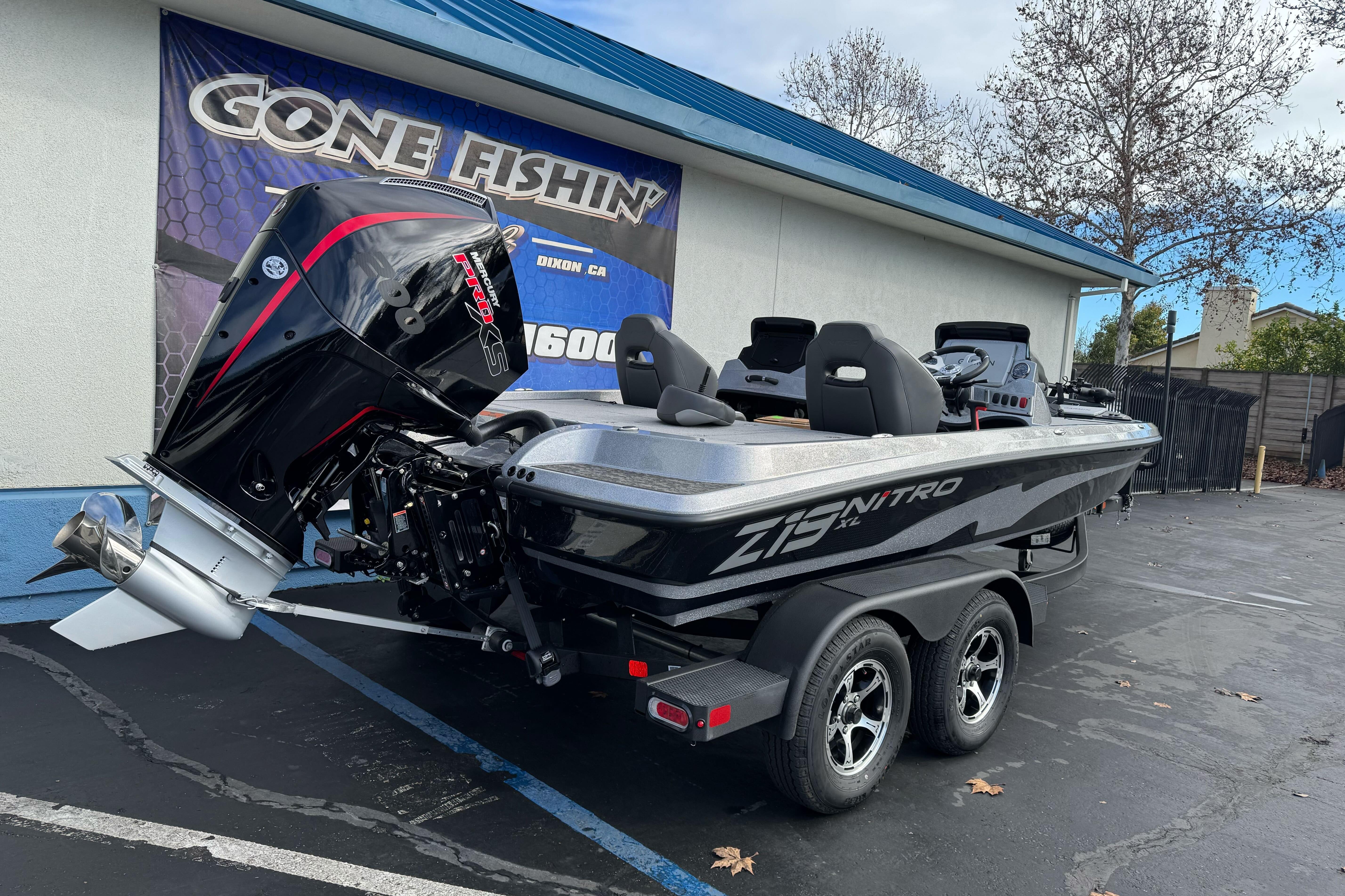 2026 Nitro Z19 XL boat on trailer, parked outside a fishing store.
