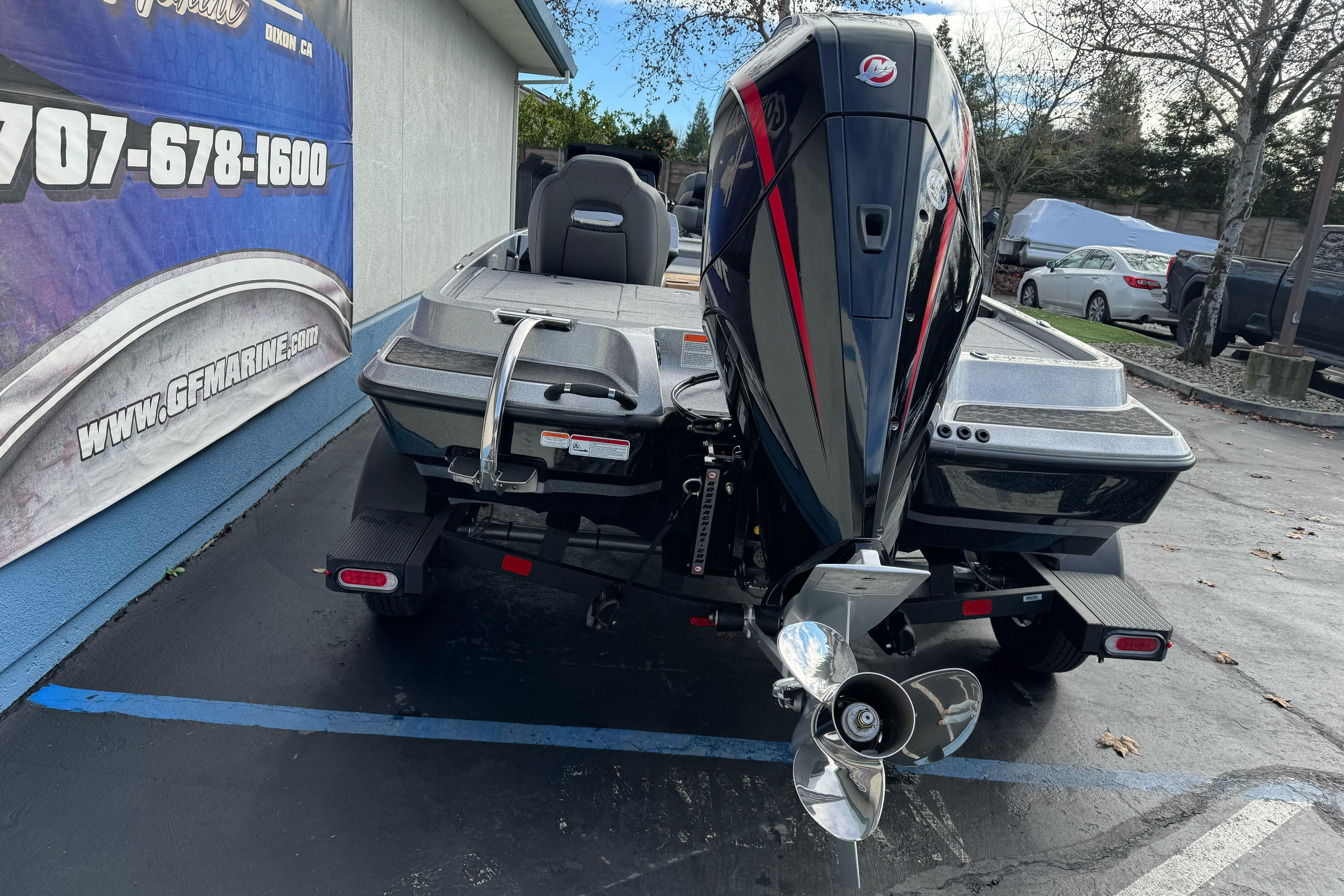 2026 Nitro Z19 XL boat with powerful outboard motor in parking lot.