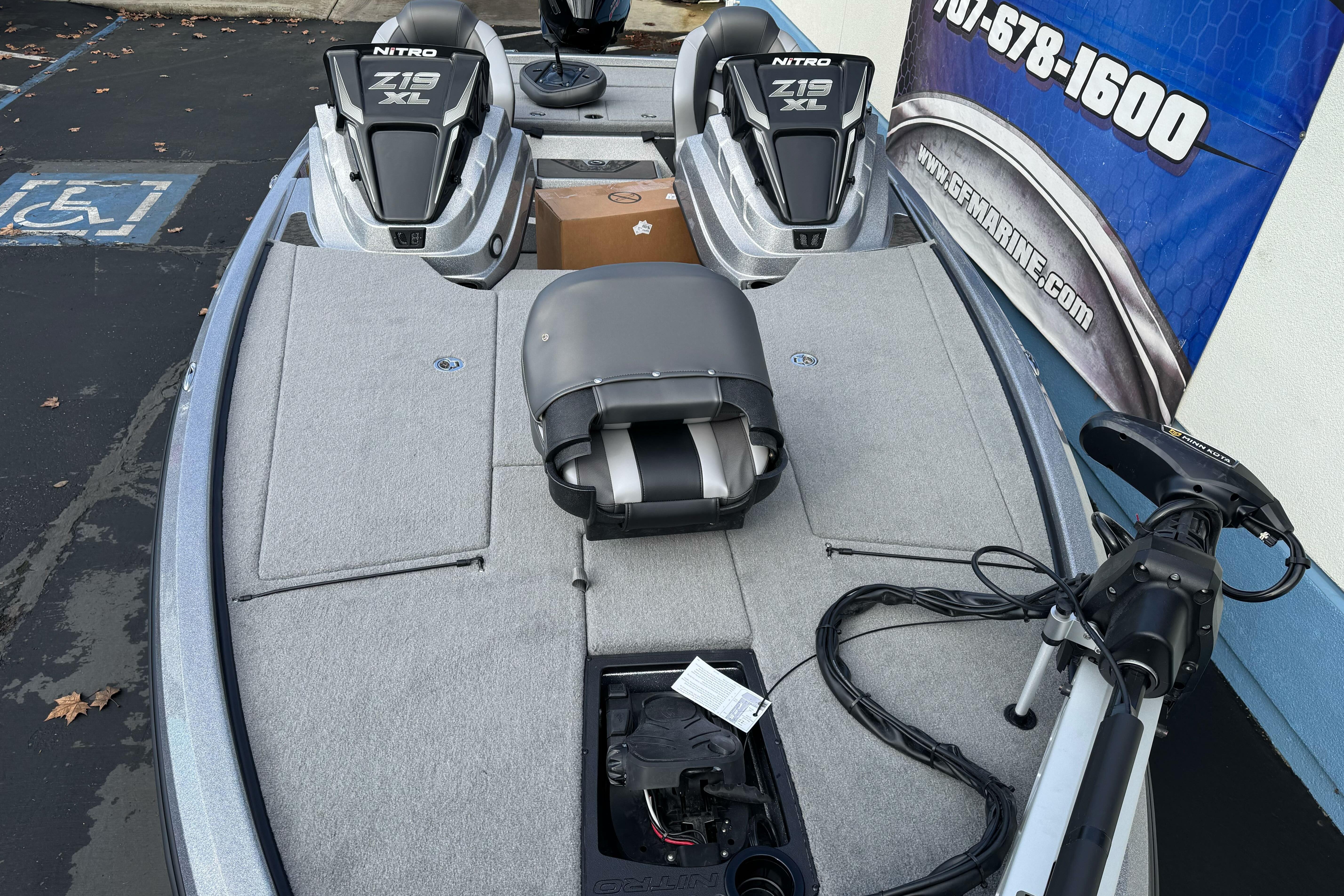 2026 Nitro Z19 XL boat with dual seats and trolling motor in parking lot.