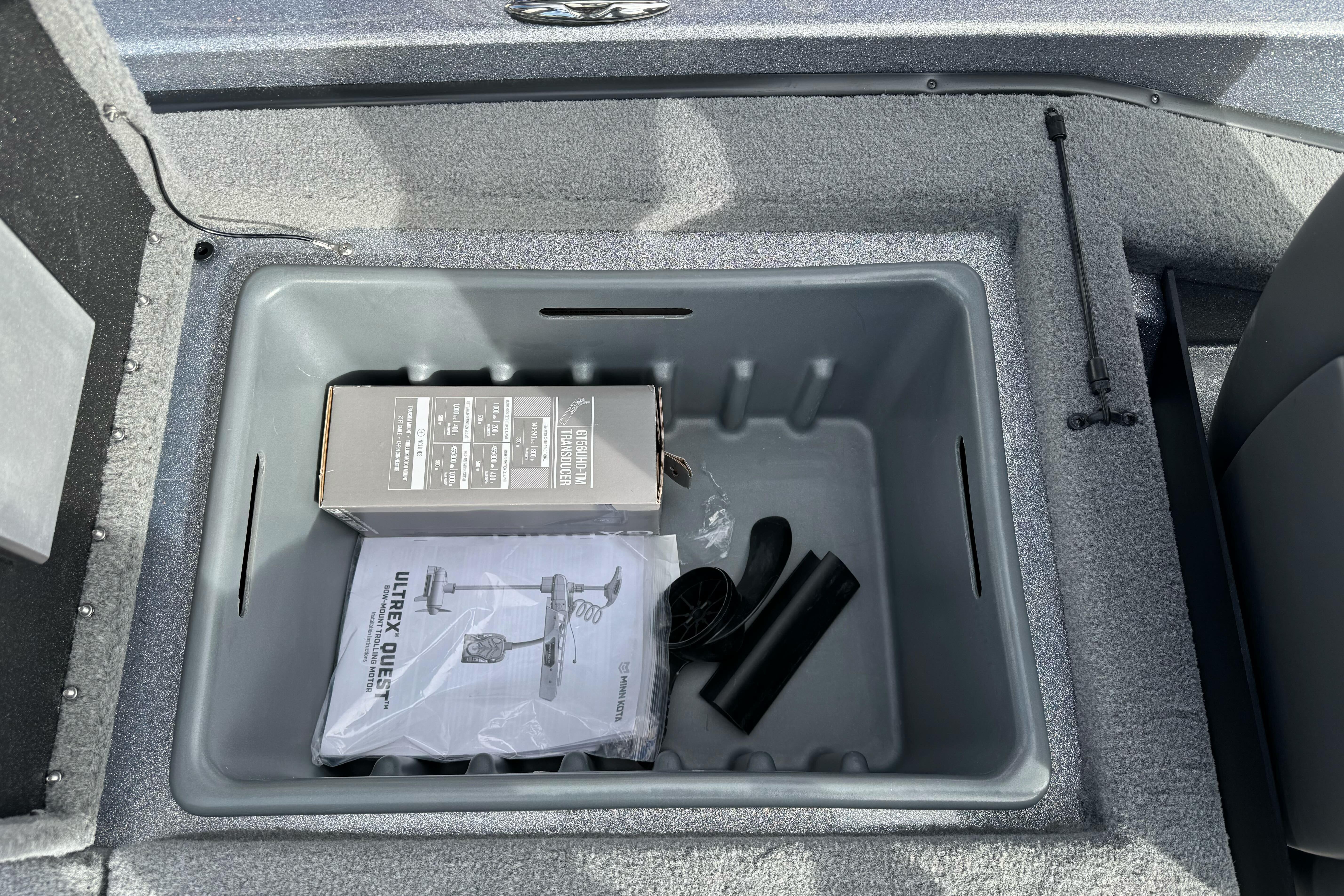 Storage compartment in 2026 Nitro Z19 XL boat with accessories and manuals.