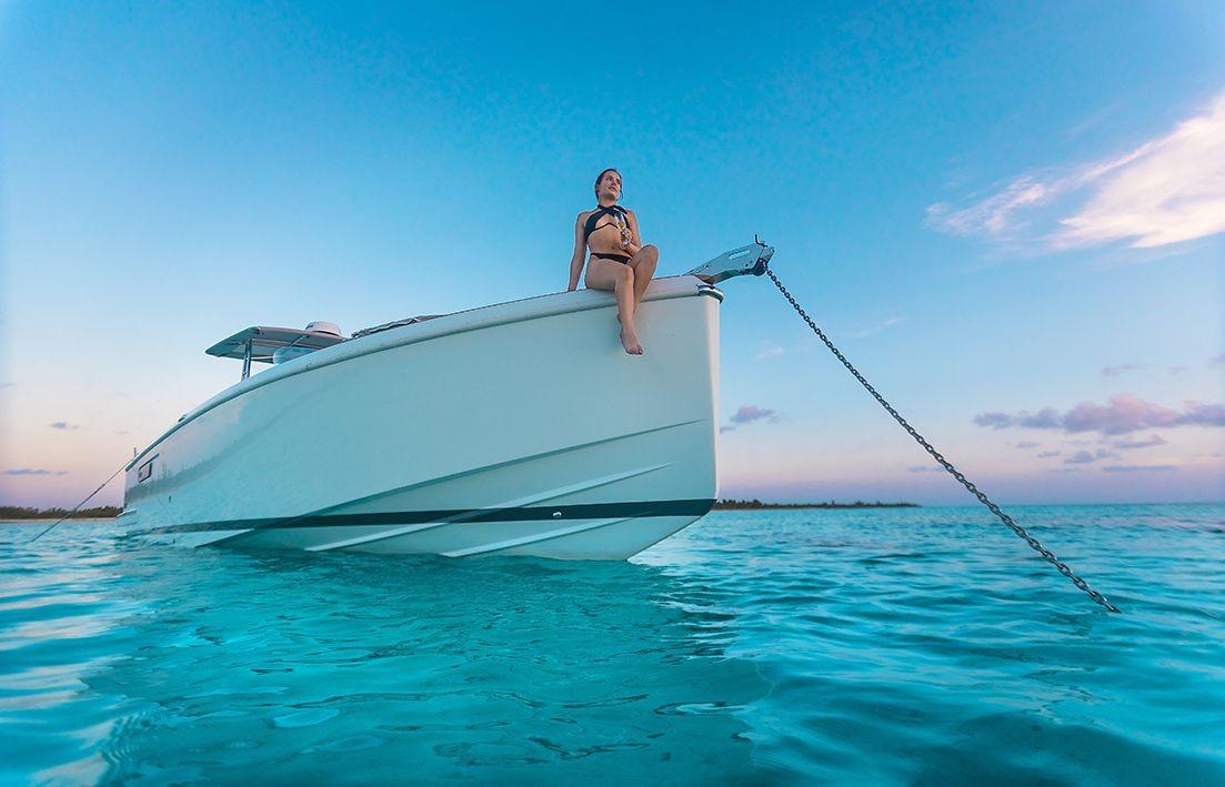 Fjord-36 Open 2018 -FL-US-Woman sitting on the bow of a 2018 Fjord 36 Open boat anchored in clear blue water.-9391029 | Thumbnail