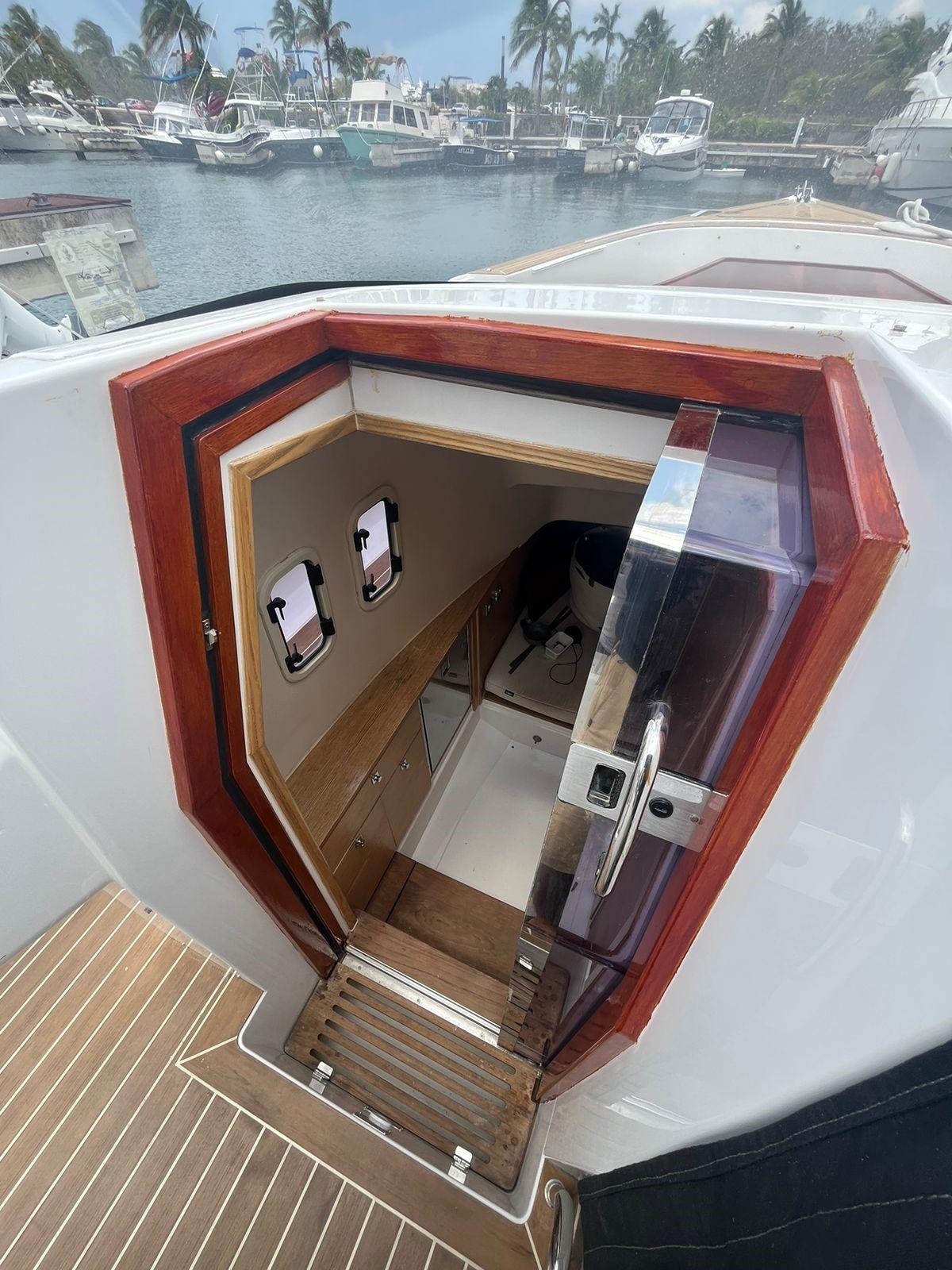 Fjord-36 Open 2018 -FL-US-2018 Fjord 36 Open yacht cabin entrance with wooden trim and marina view.-9391029 | Thumbnail