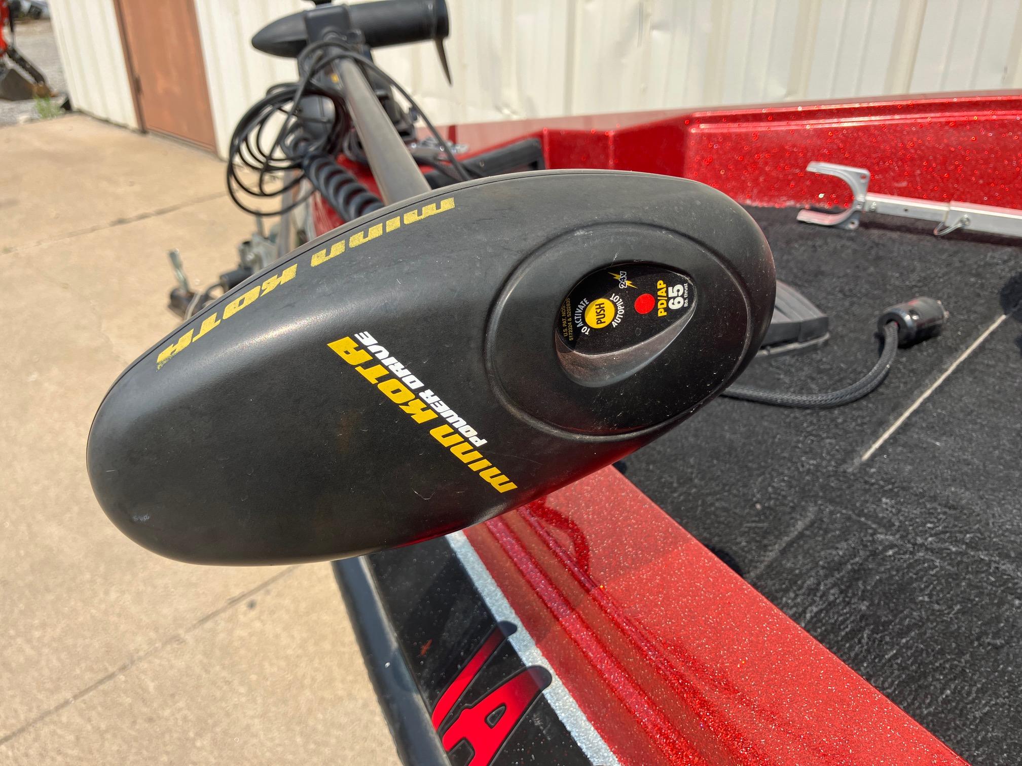 Minn Kota trolling motor on 1990 Astro 17 1/2' bass boat, red finish, outdoor setting.