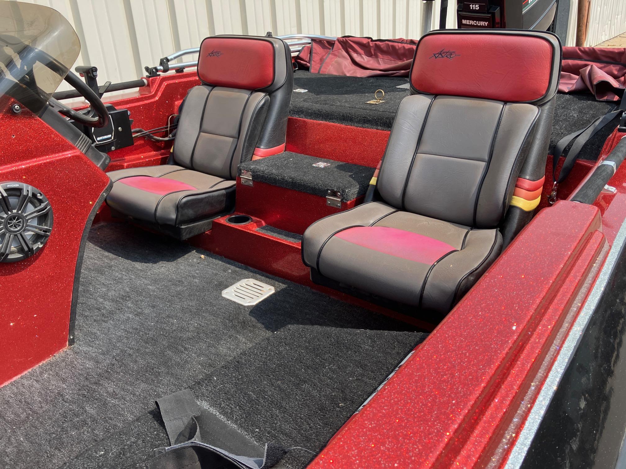 Red 1990 Astro 17 1/2' Bass Boat interior with dual seats and carpeted flooring.