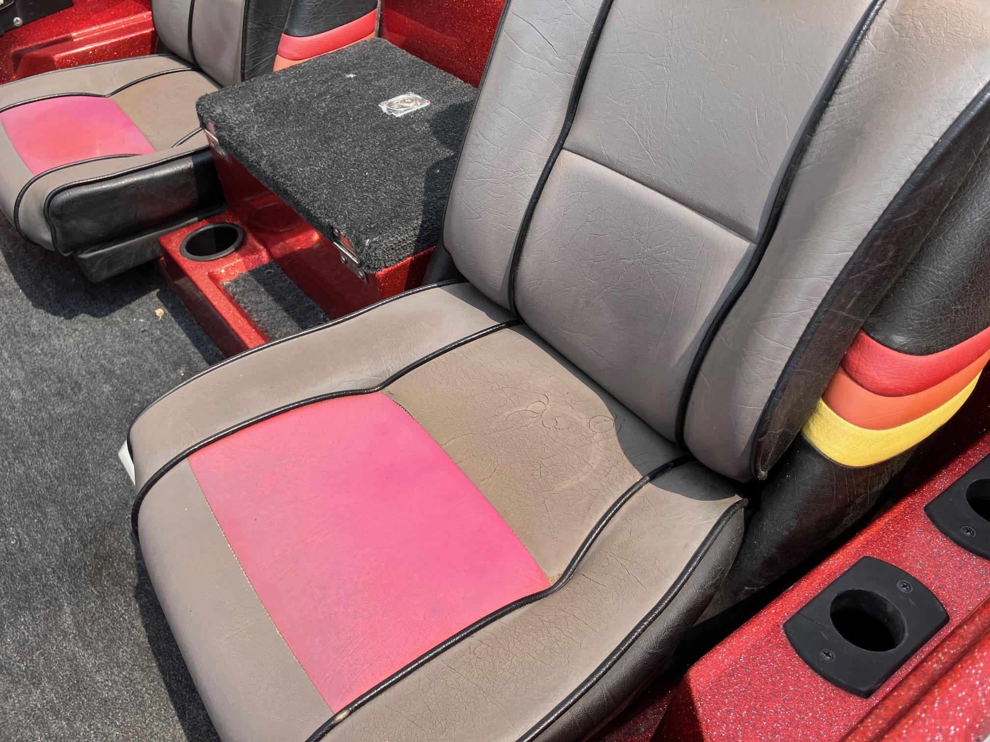 1990 Astro 17 1/2' Bass Boat interior with red and gray seating.