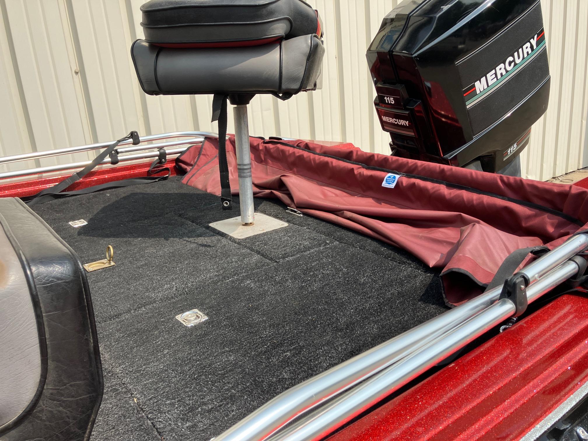 1990 Astro 17 1/2' Bass Boat with Mercury engine and red interior.