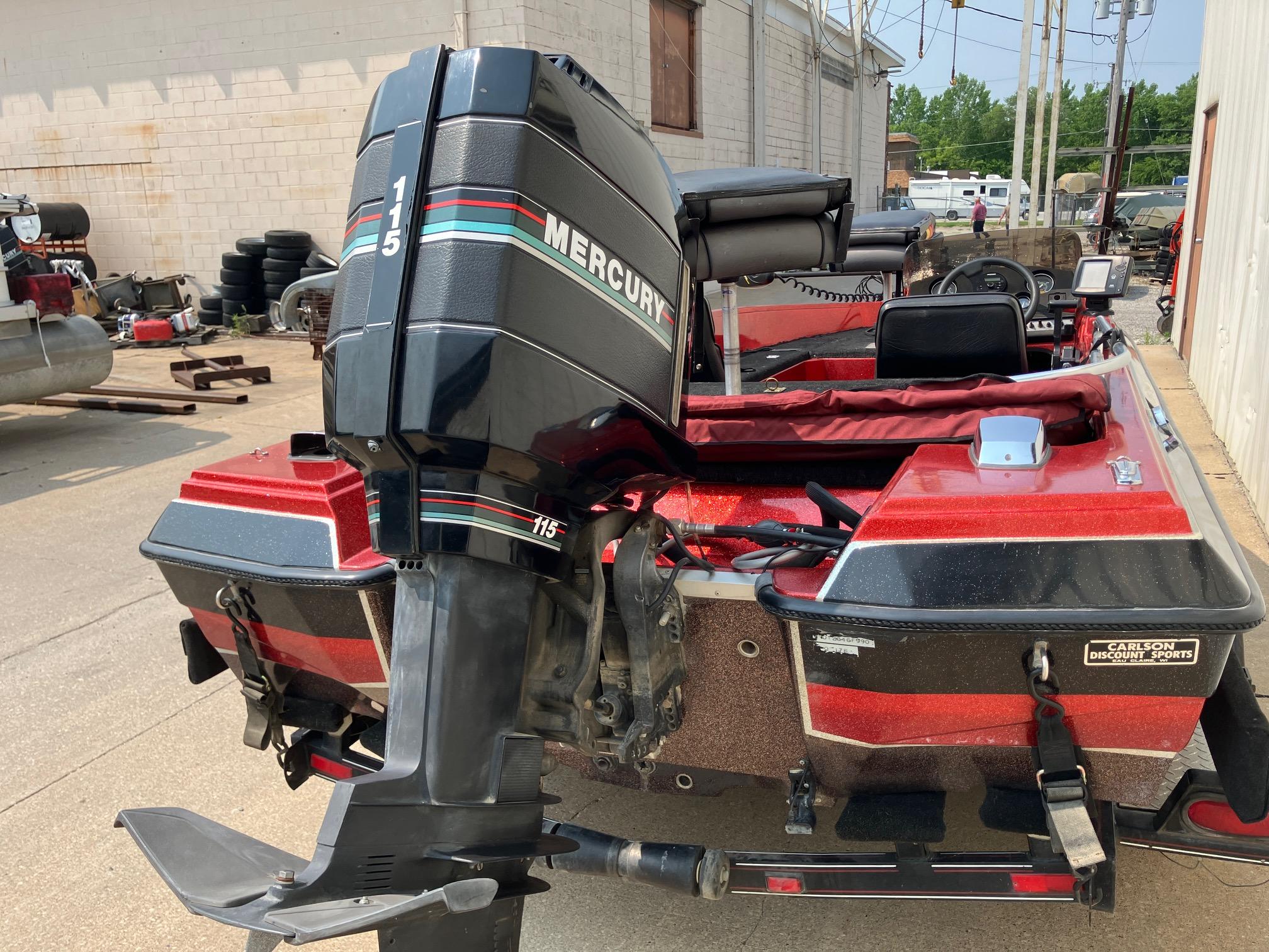 1990 Astro 17 1/2' Bass Boat with Mercury 115 outboard motor, parked outdoors.