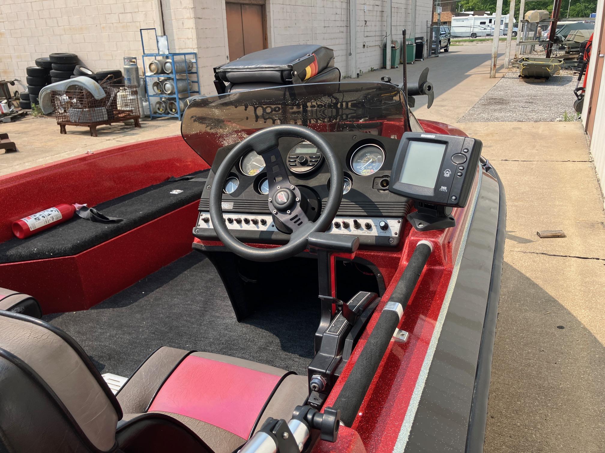 1990 Astro 17 1/2' Bass Boat interior with steering wheel and control panel.