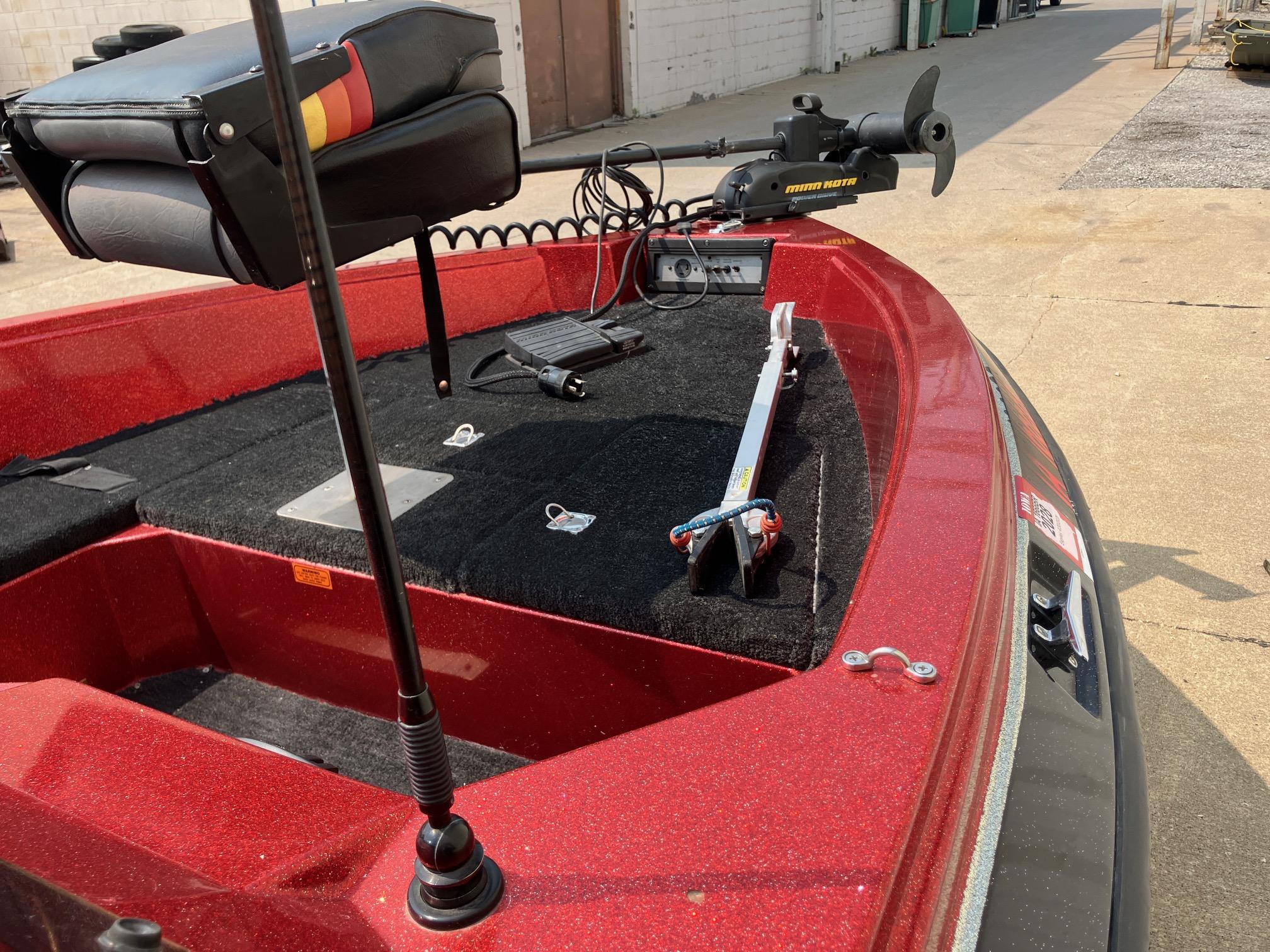 Red 1990 Astro 17 1/2' Bass Boat with trolling motor and seating.