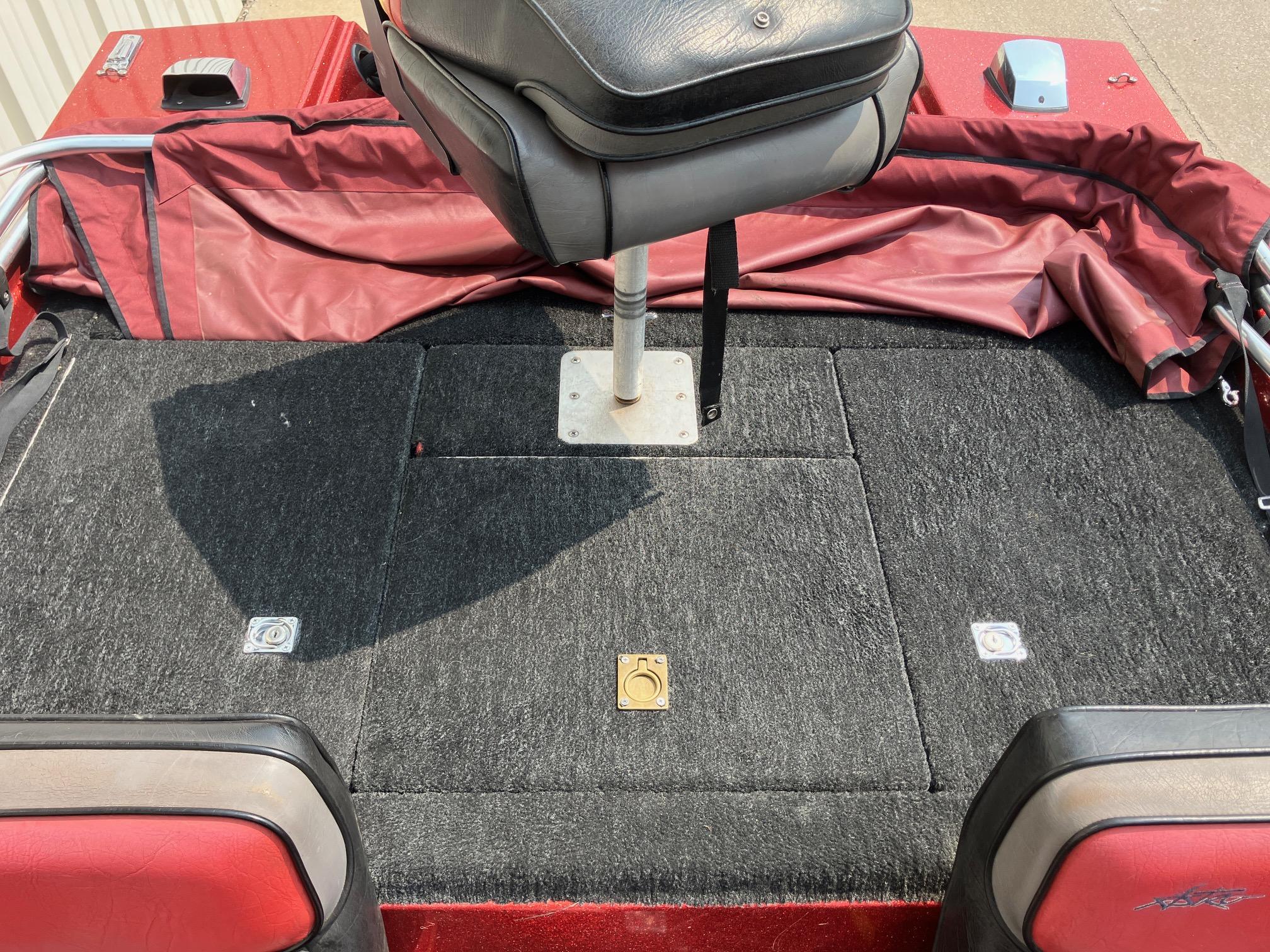 1990 Astro 17 1/2' Bass Boat interior with red and black seating and carpeted deck.