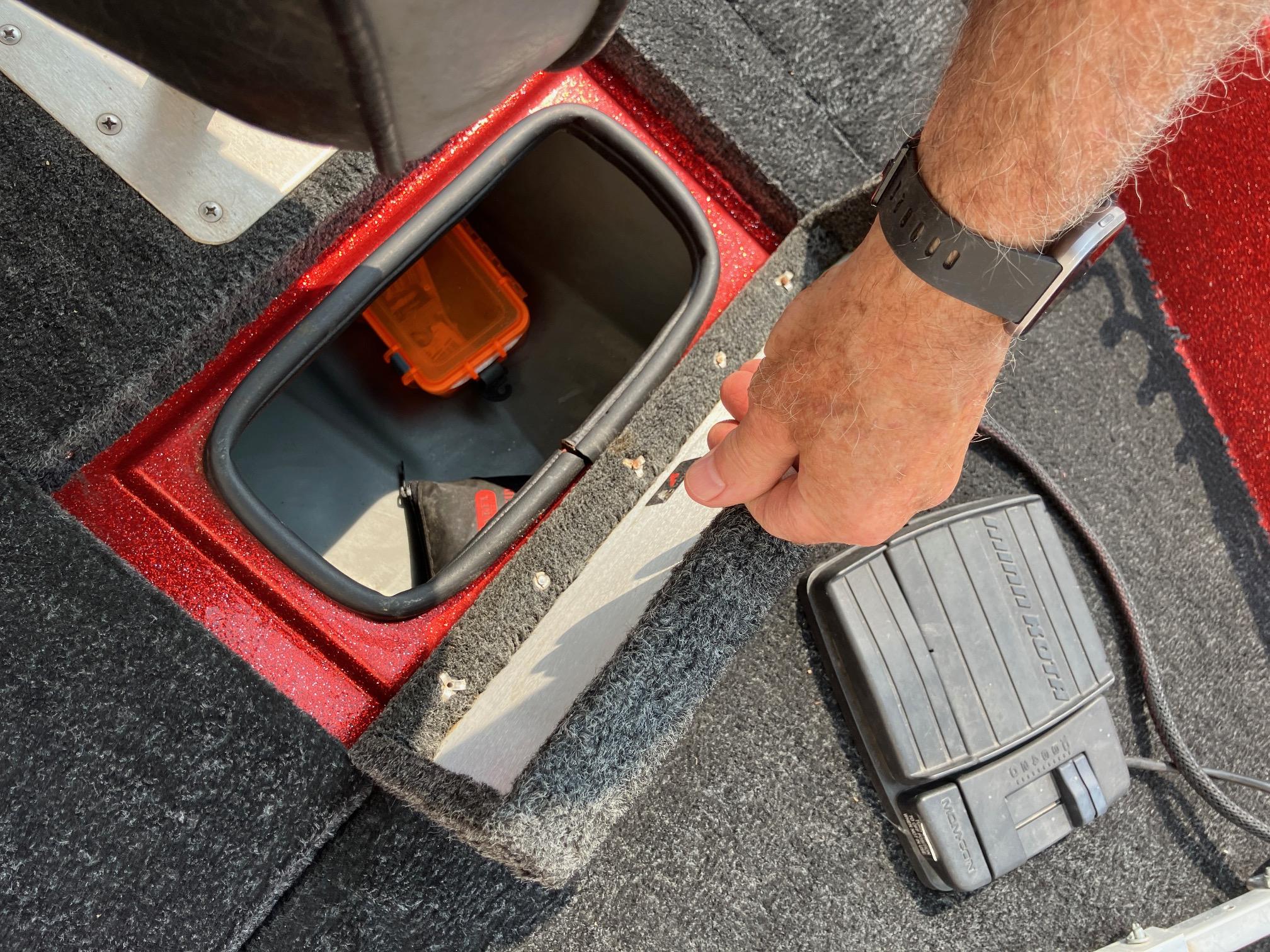 1990 Astro 17 1/2' Bass Boat storage compartment with pedal and hand opening lid.