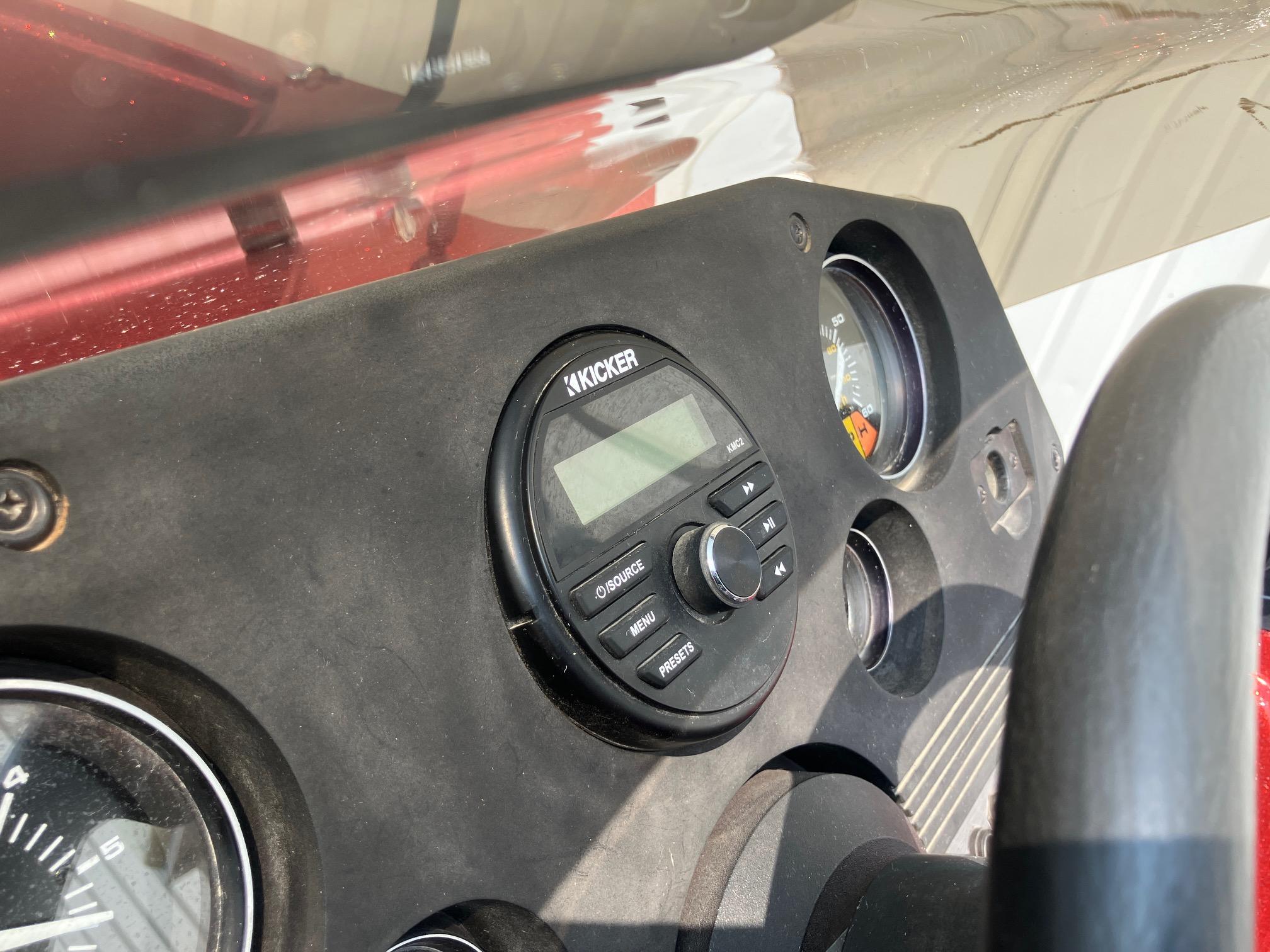 Dashboard of a 1990 Astro 17 1/2' Bass Boat with Kicker audio system.