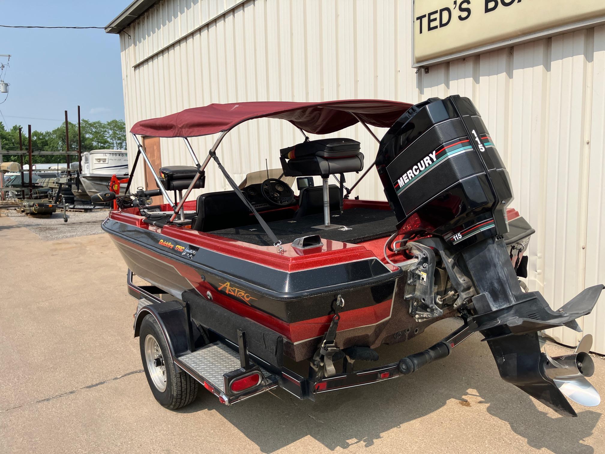 1990 Astro 17 1/2' Bass Boat with Mercury engine, parked outside a boat shop.