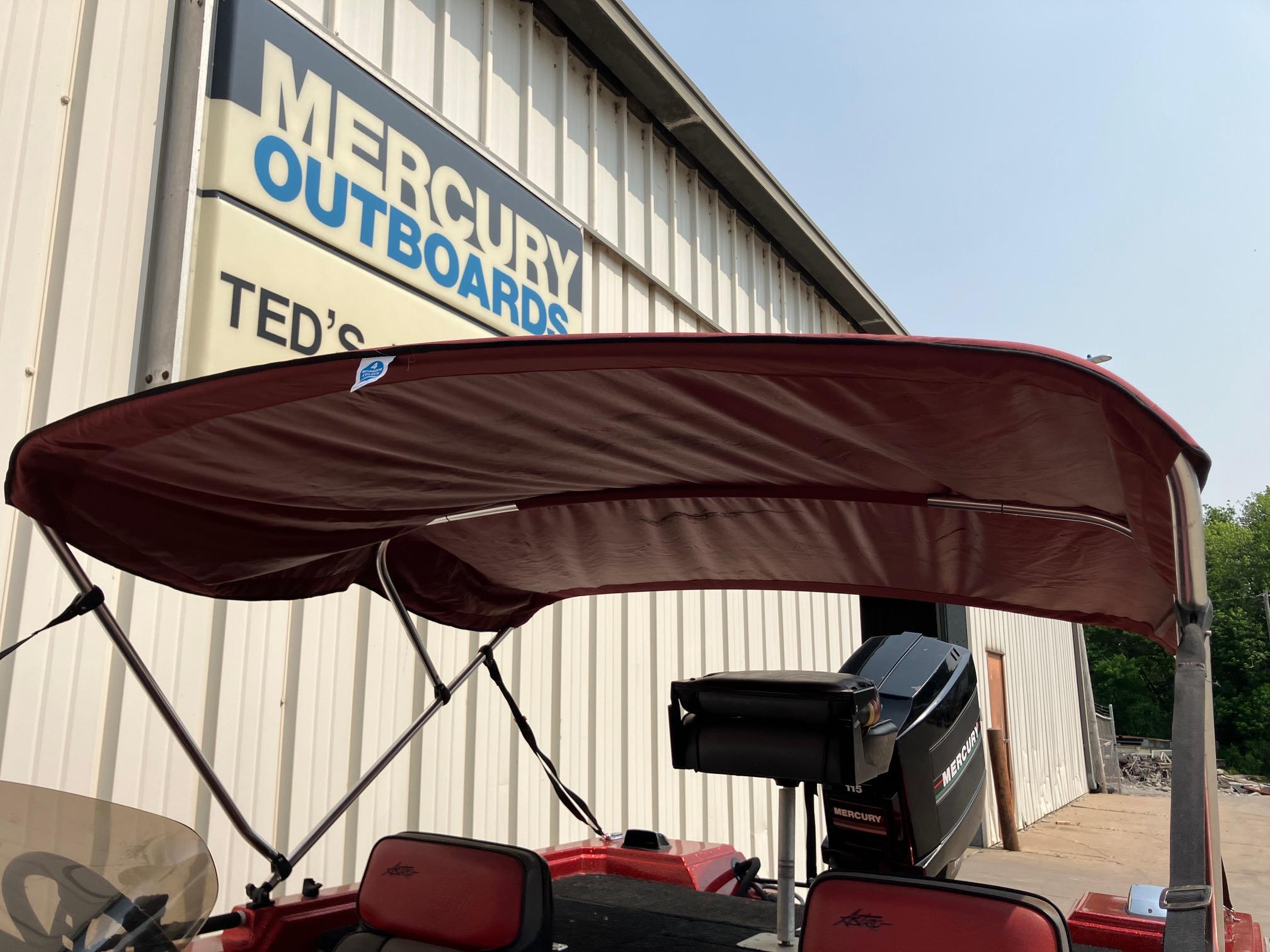 1990 Astro 17 1/2' Bass Boat with canopy at Mercury Outboards shop.