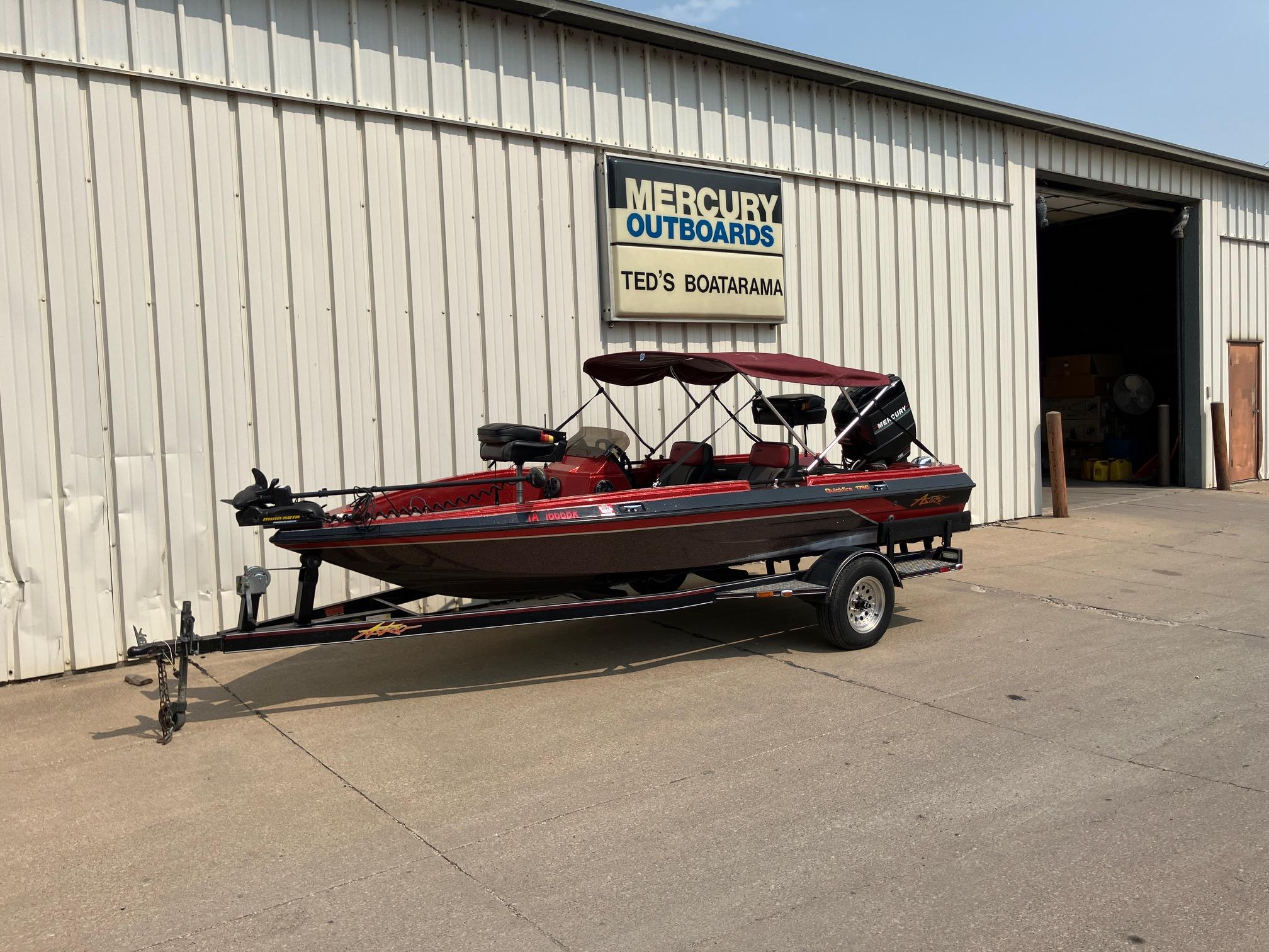 1990 Astro 17 1/2' Bass Boat on trailer outside Ted's Boatarama.