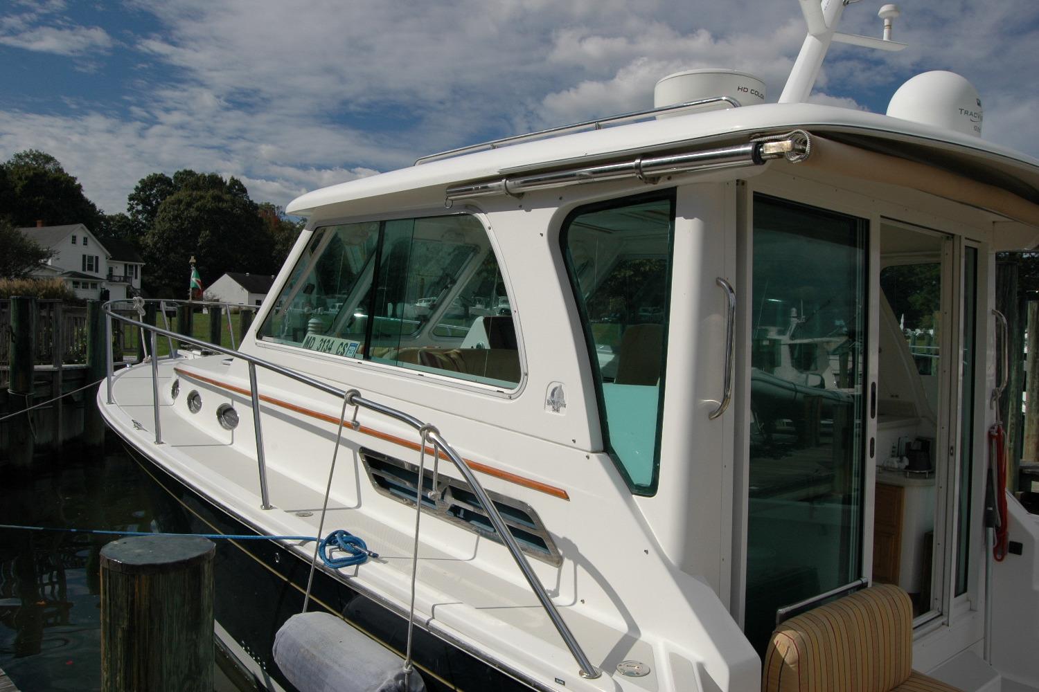 2014 Back Cove 34 boat docked, showcasing sleek design and spacious cabin.
