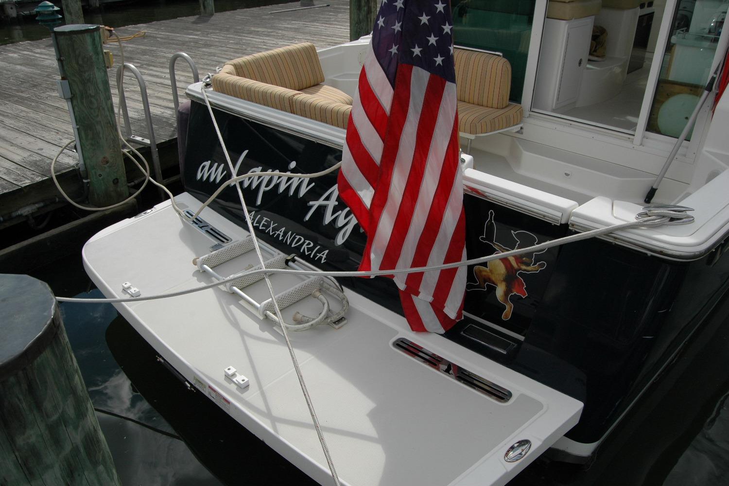 2014 Back Cove 34 boat docked with American flag and striped seating.