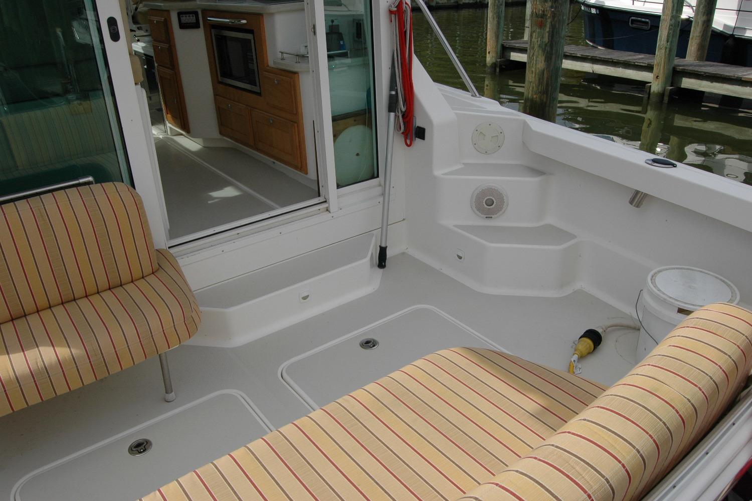 2014 Back Cove 34 boat interior with striped seating and kitchenette.