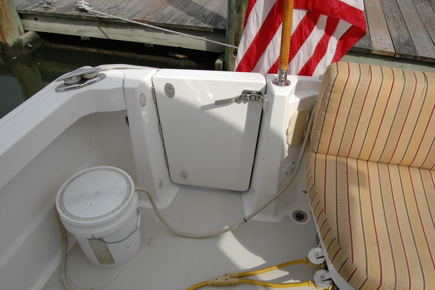 2014 Back Cove 34 boat interior with striped seating, American flag, and dock view.