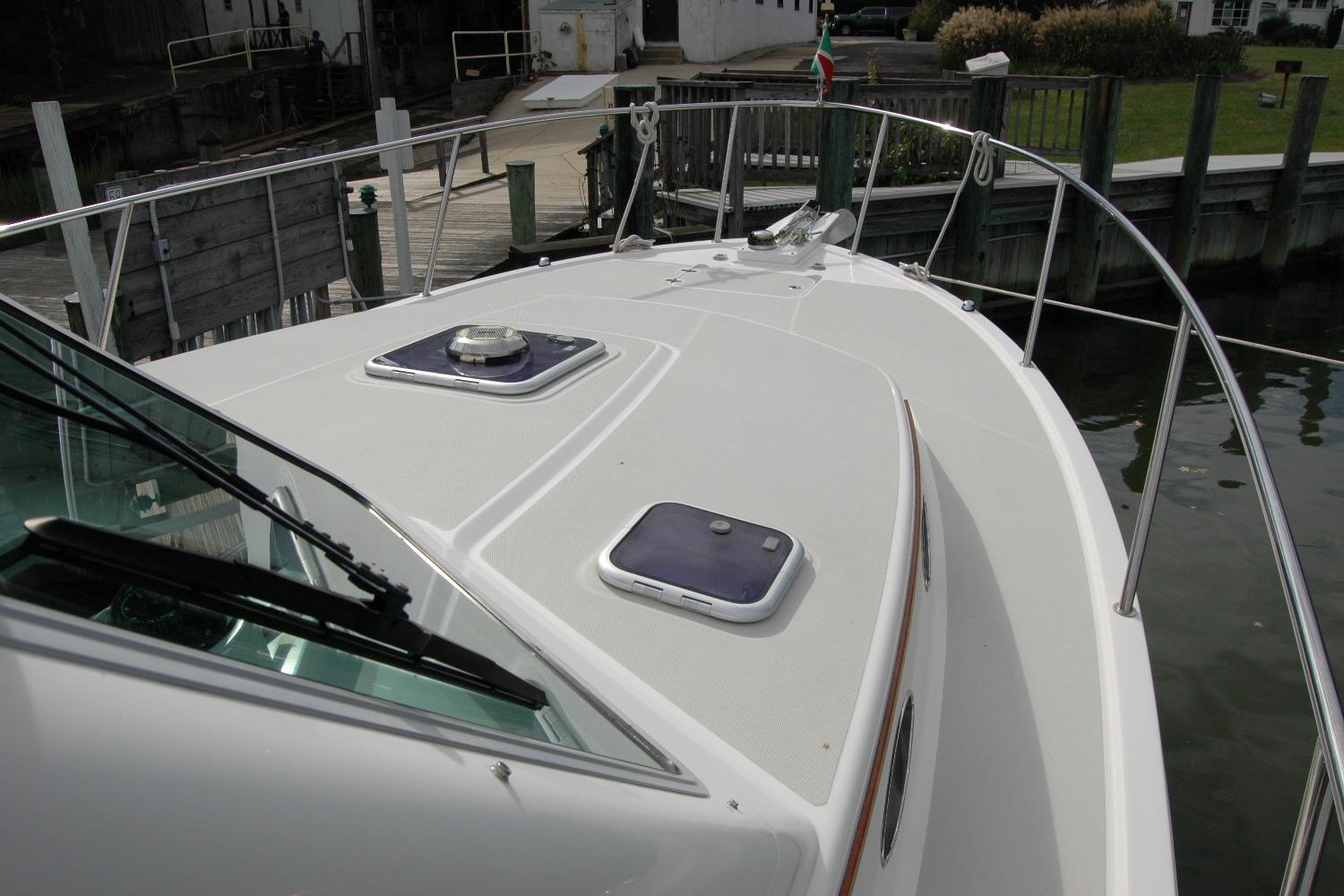 2014 Back Cove 34 boat deck with hatches, docked at marina.