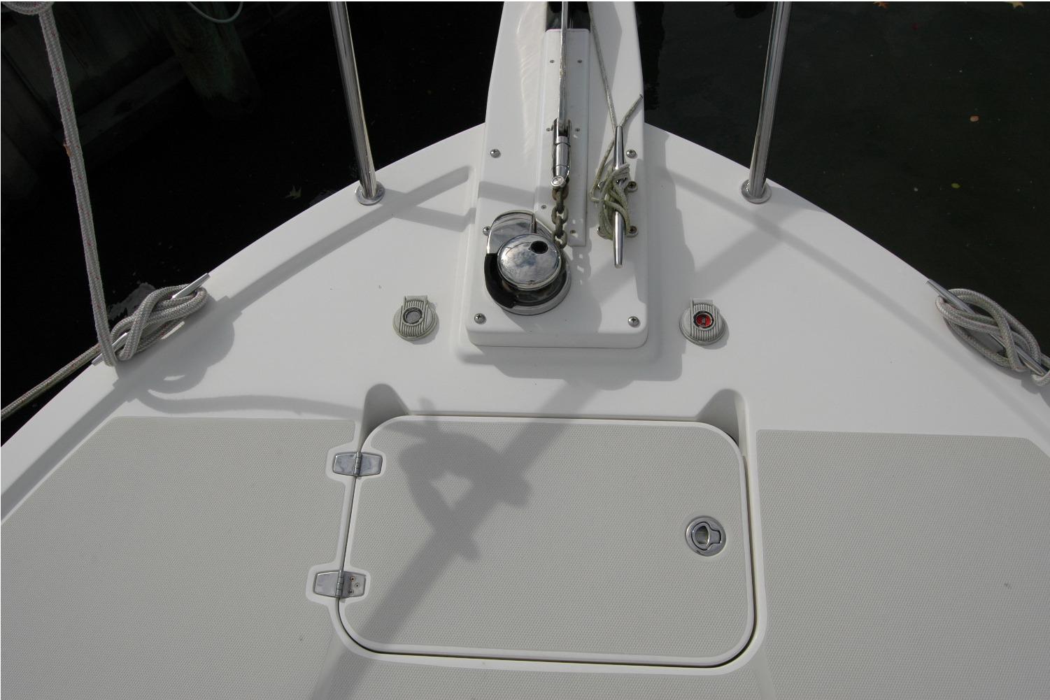 Bow deck of 2014 Back Cove 34 boat with anchor winch and storage hatch.