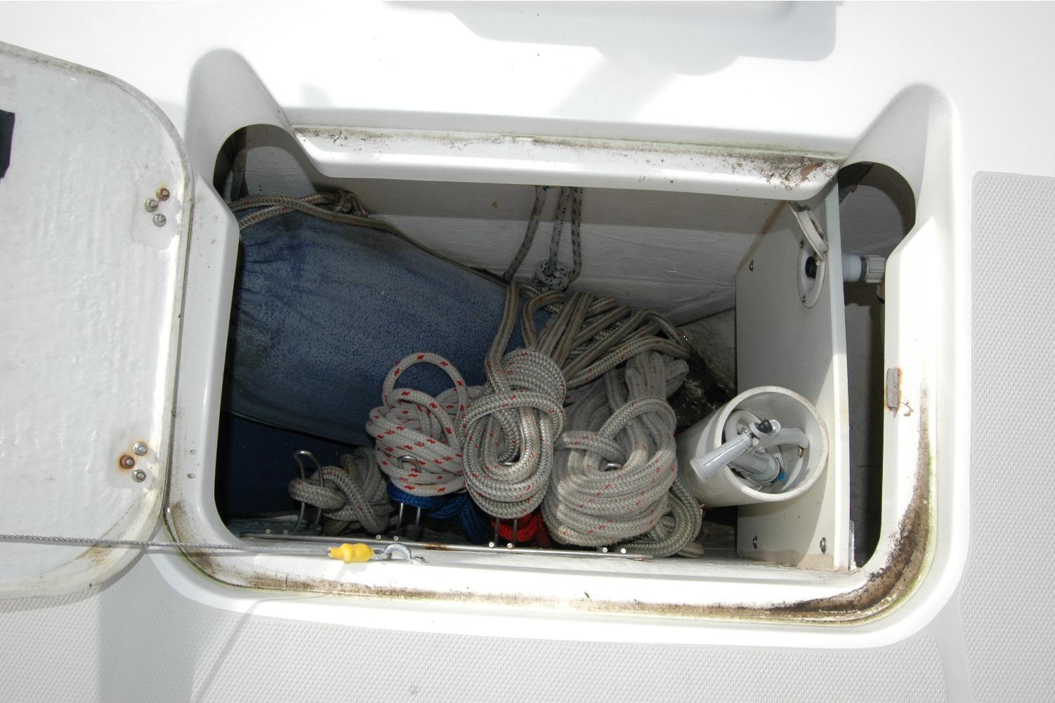 Storage compartment on a 2014 Back Cove 34 boat with ropes and equipment.