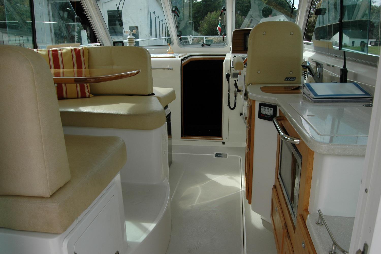 Interior of a 2014 Back Cove 34 boat with seating and kitchenette.