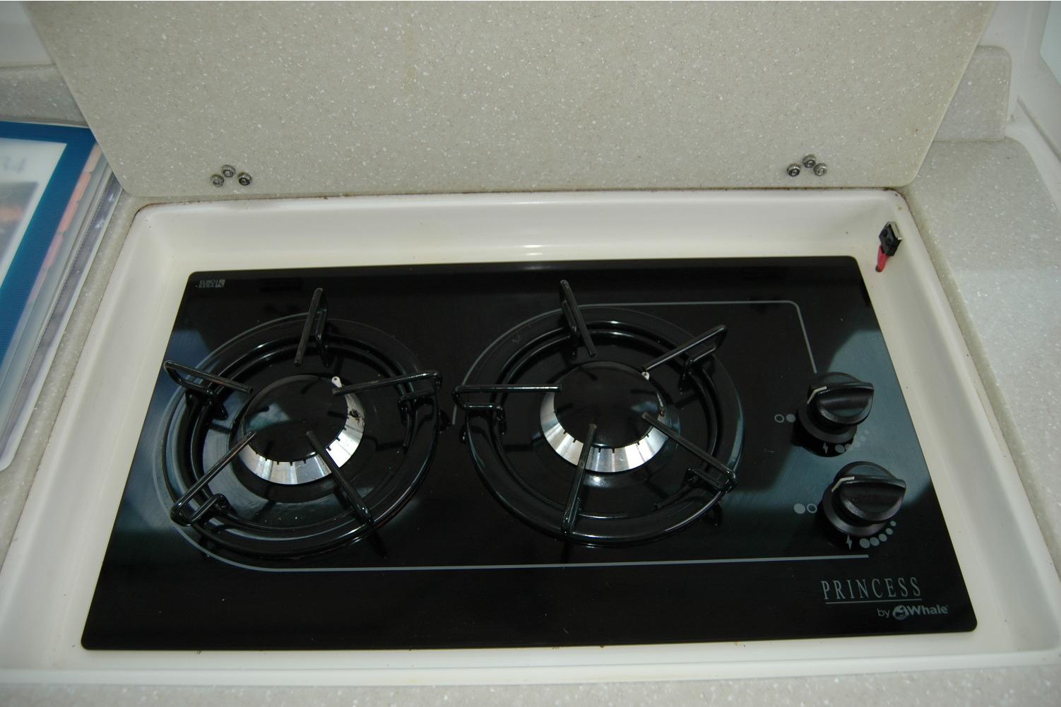 Gas stove in 2014 Back Cove 34 yacht kitchen, featuring two burners and sleek design.
