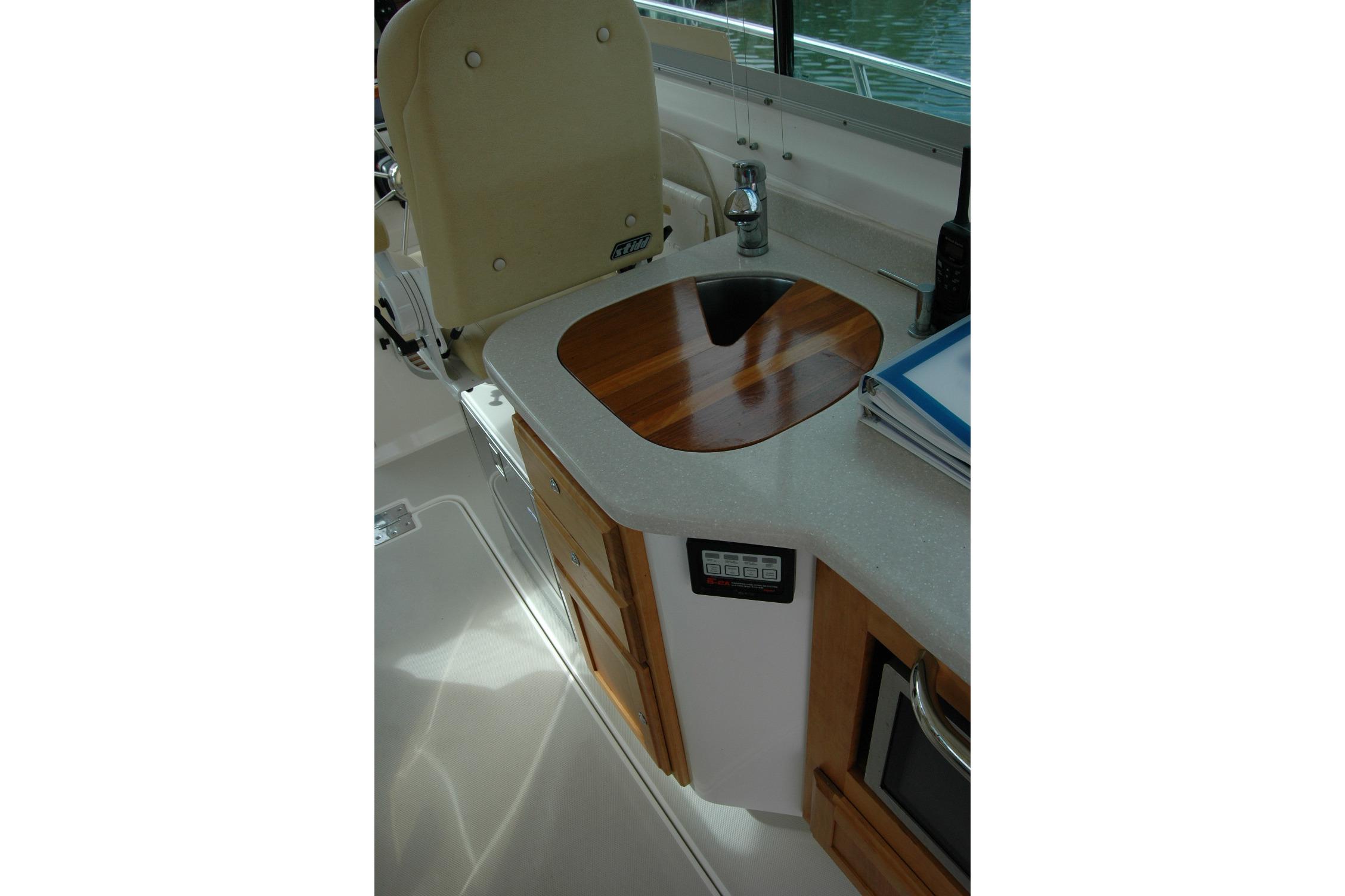 2014 Back Cove 34 boat interior with sink, countertop, and storage cabinets.