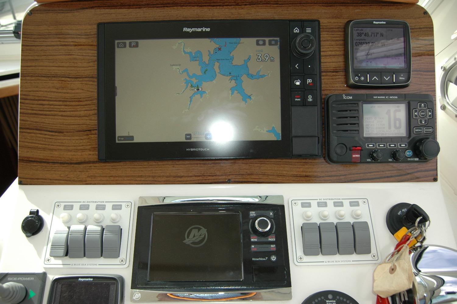 2014 Back Cove 34 helm with navigation and communication equipment, featuring Raymarine and Icom systems.