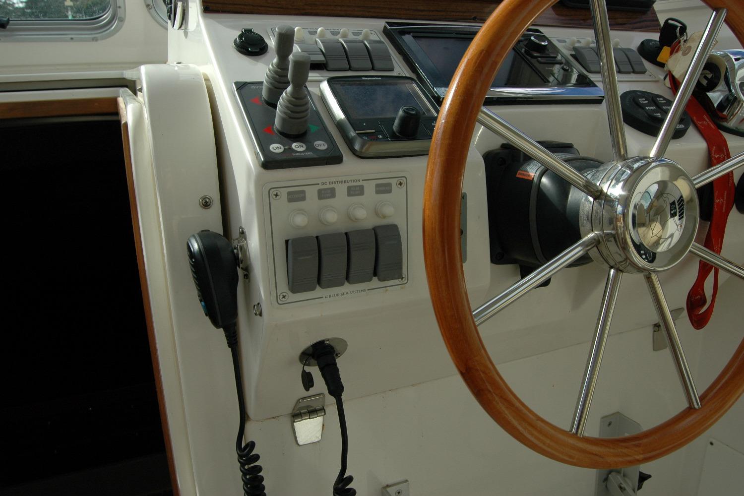 Steering wheel and controls of a 2014 Back Cove 34 boat cockpit.