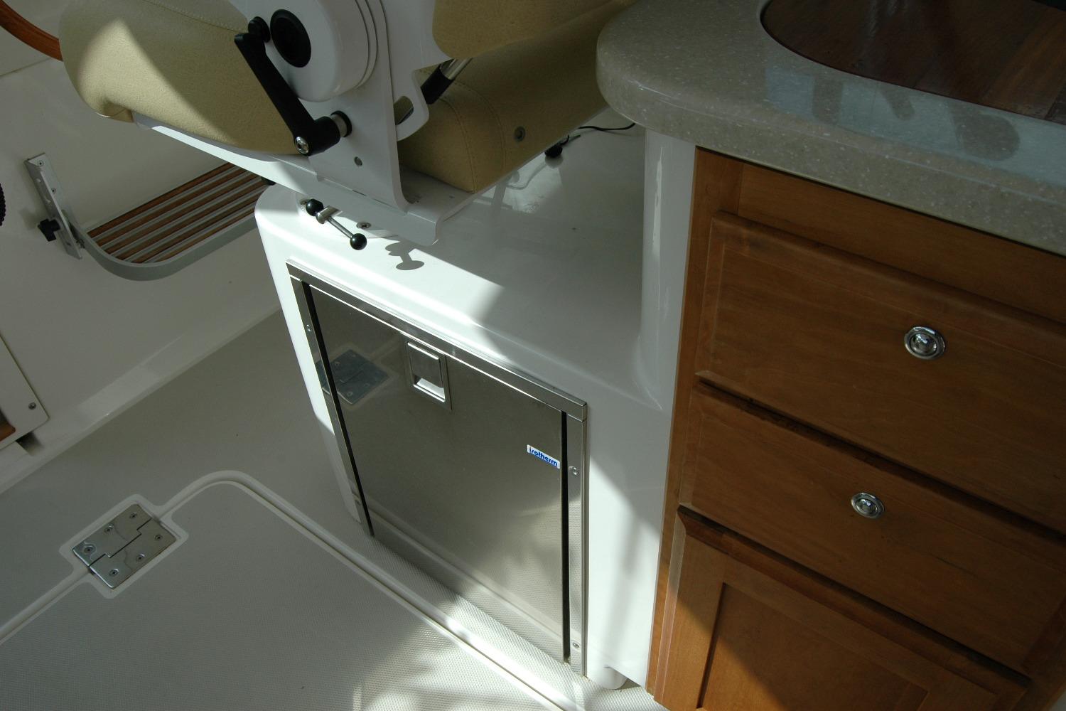 Interior of 2014 Back Cove 34 boat with seating and cabinetry.