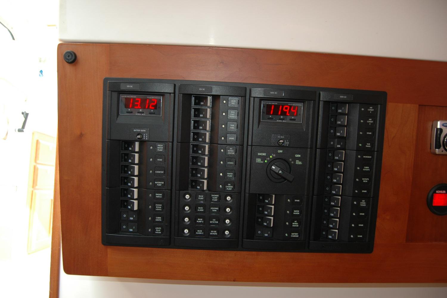 Electrical panel of a 2014 Back Cove 34 boat, featuring digital displays and switches.