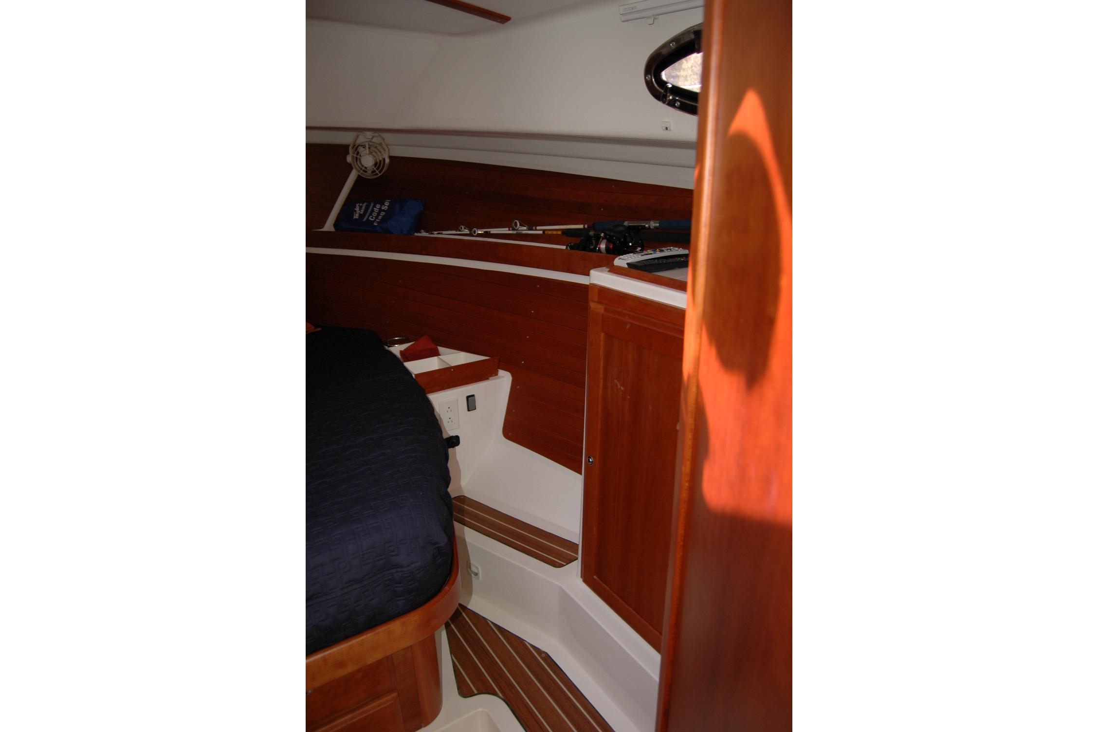 2014 Back Cove 34 cabin interior with wood finish and bed.