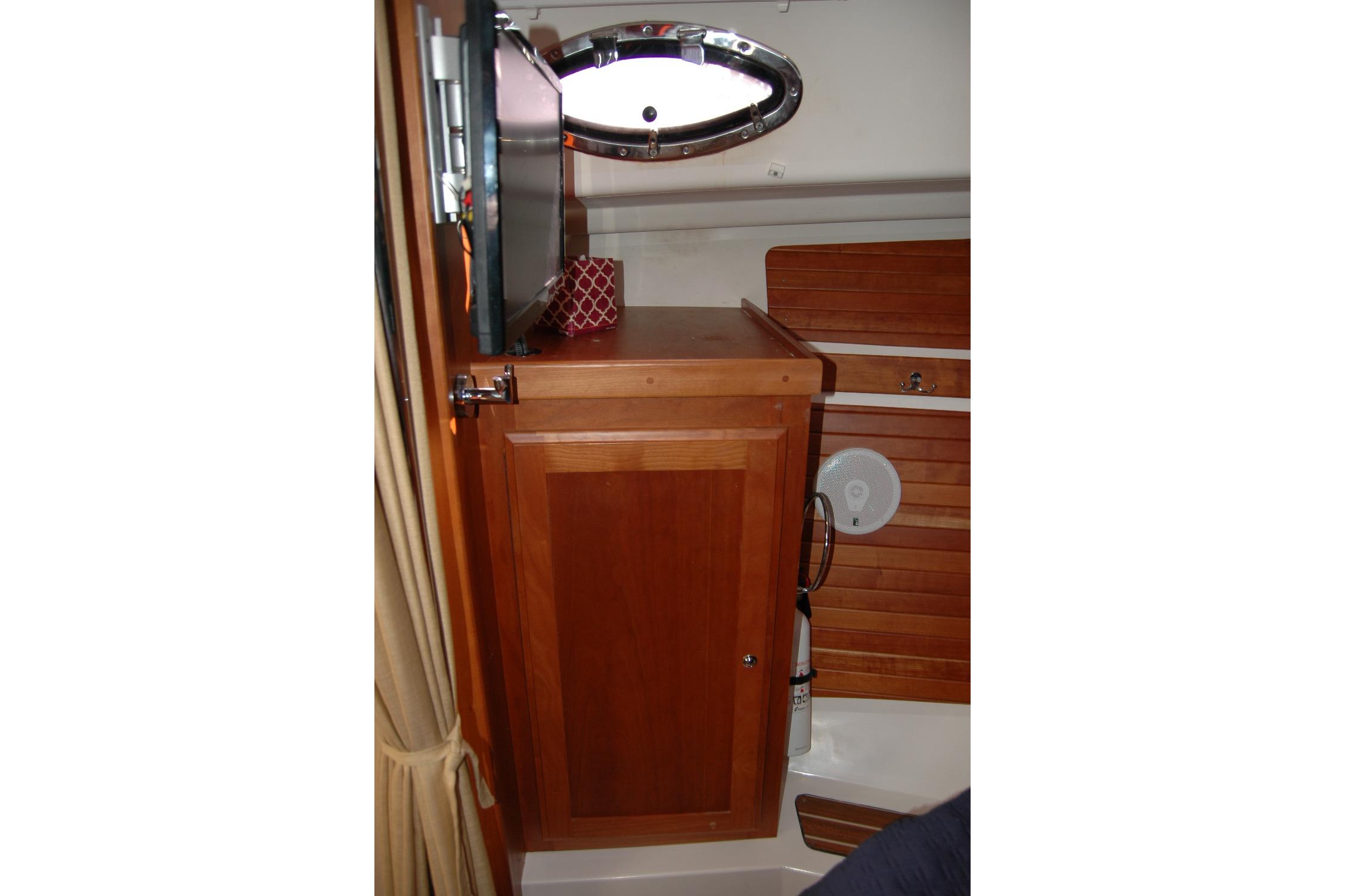 2014 Back Cove 34 interior with wooden cabinetry and porthole window.