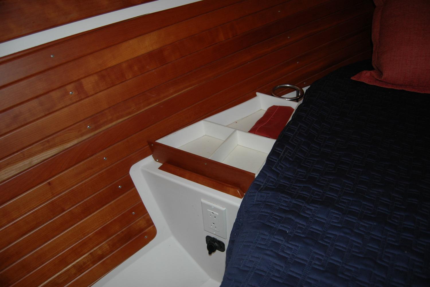 Interior of 2014 Back Cove 34 boat with wooden paneling and storage compartment.