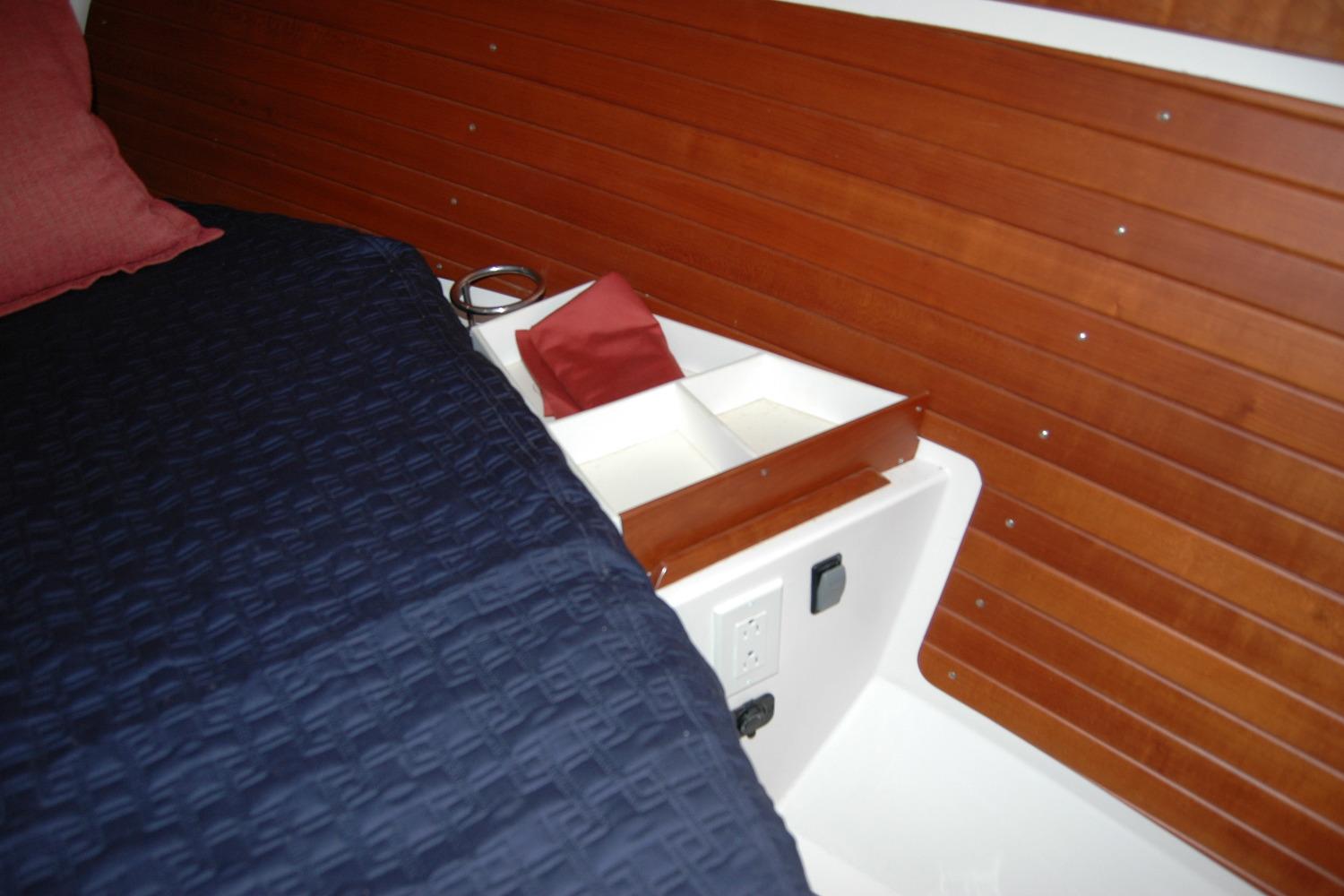 Interior of 2014 Back Cove 34 boat with wooden paneling and bed.