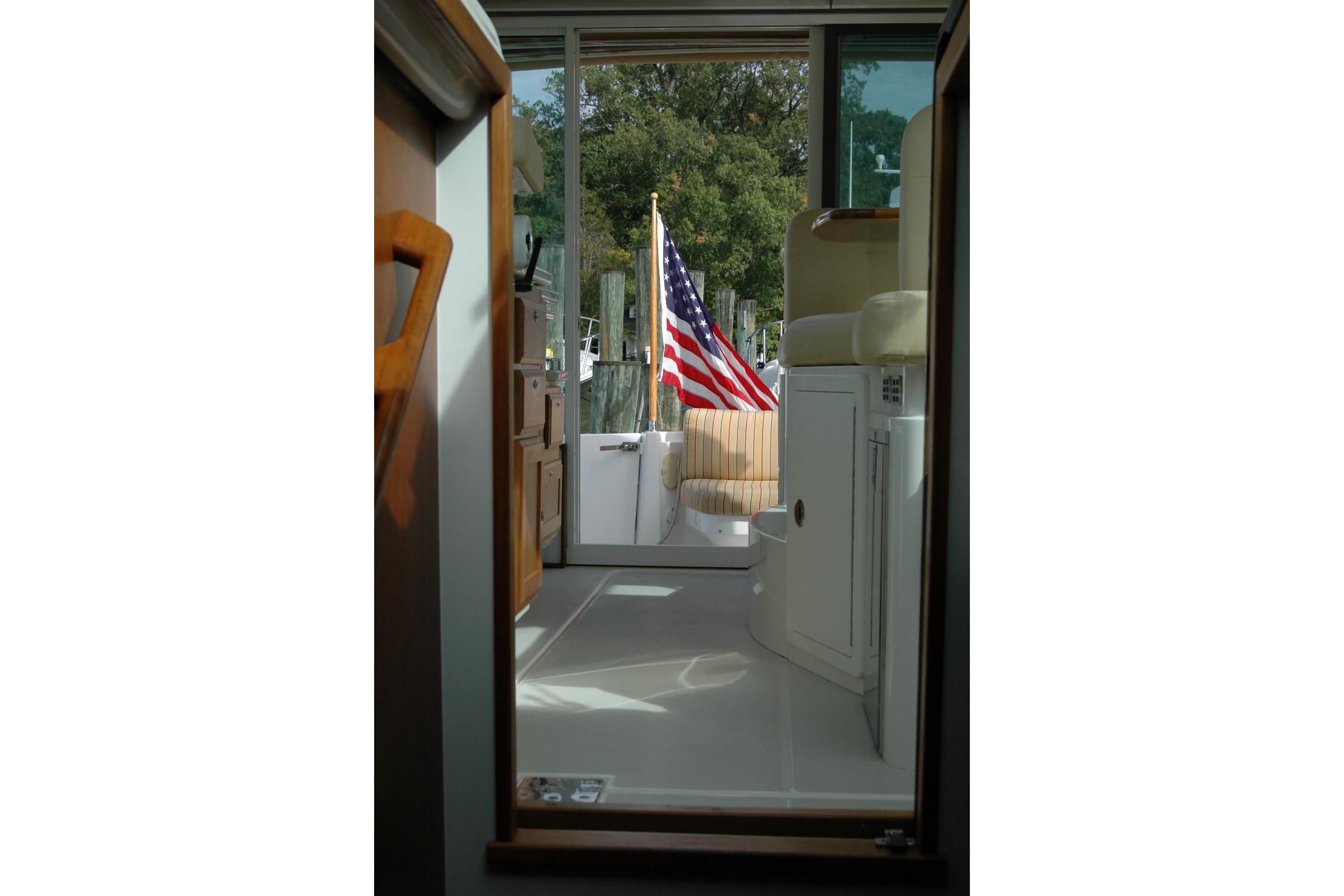 Interior view of 2014 Back Cove 34 boat with American flag visible through doorway.