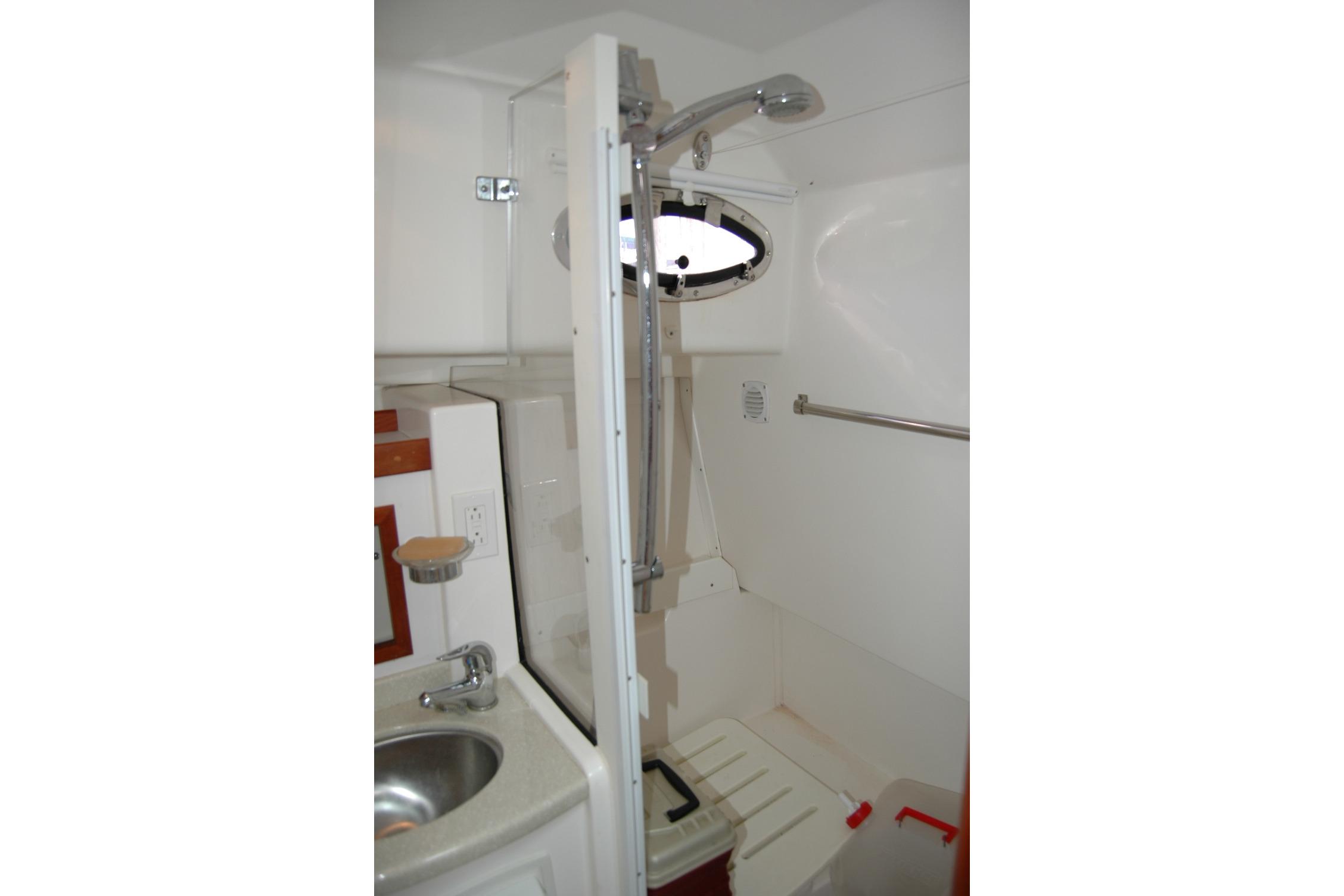 Bathroom interior of 2014 Back Cove 34 boat, featuring shower and sink.