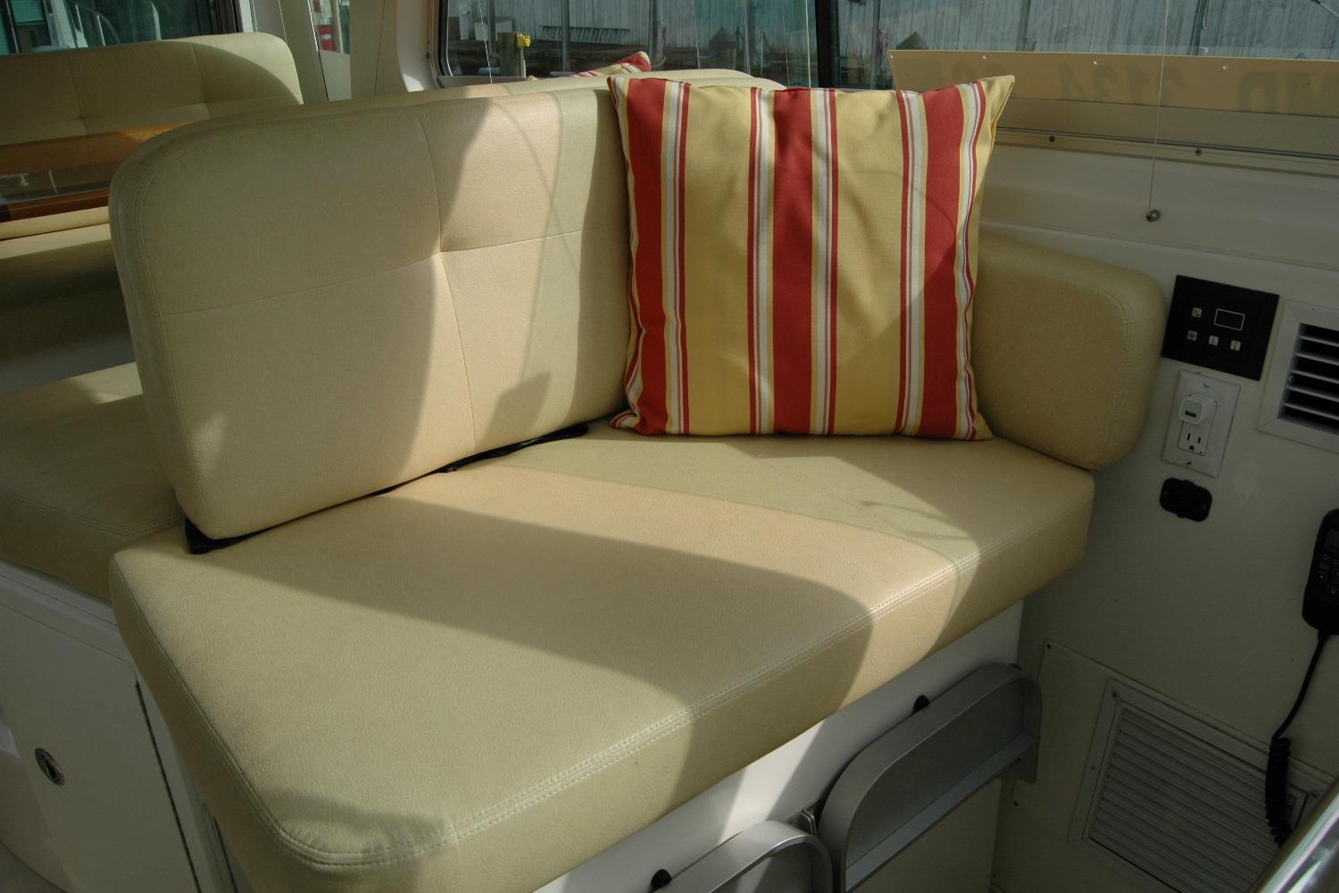 Cozy seating area on 2014 Back Cove 34 boat with striped cushion.