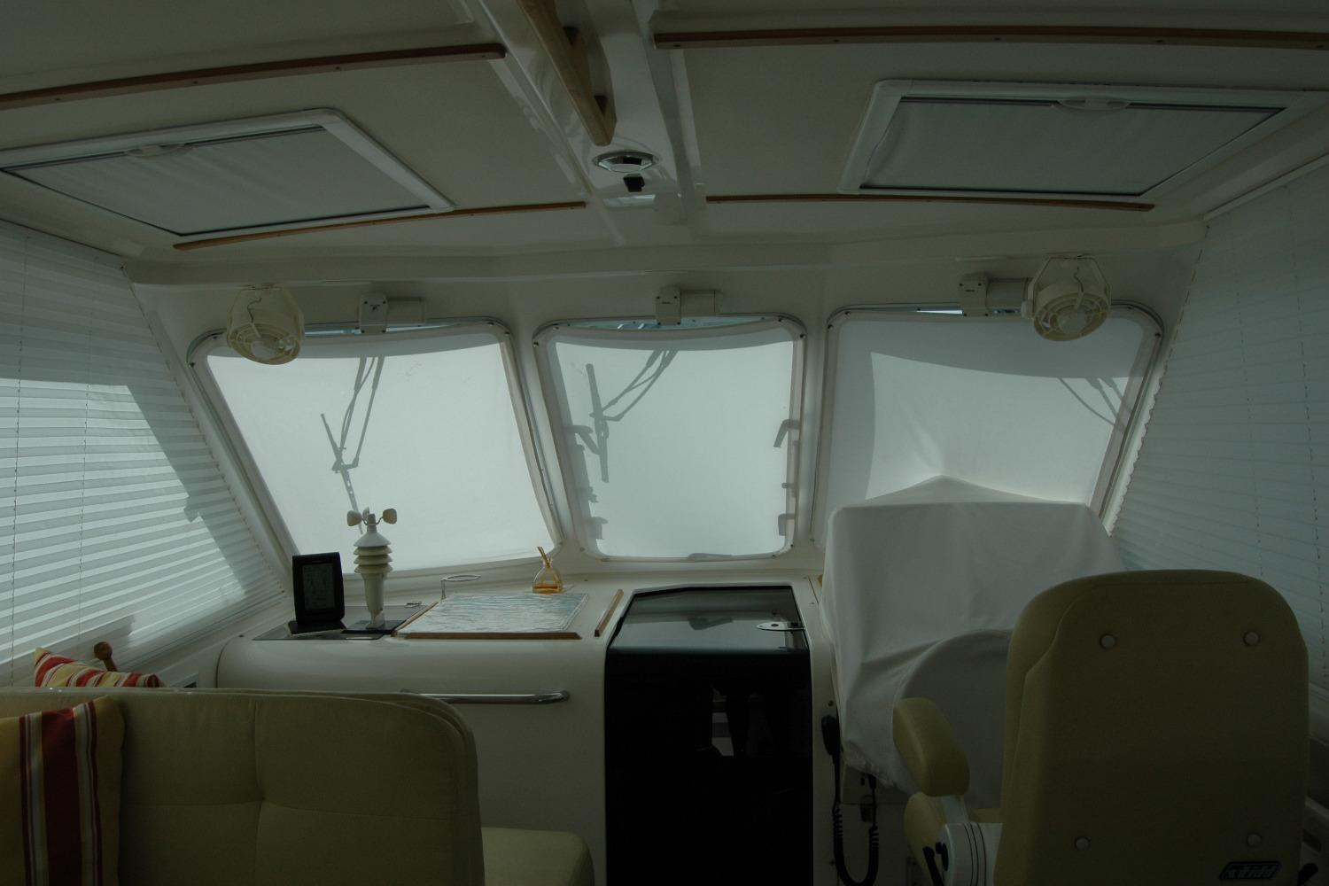 2014 Back Cove 34 boat interior with helm, windows, and seating.