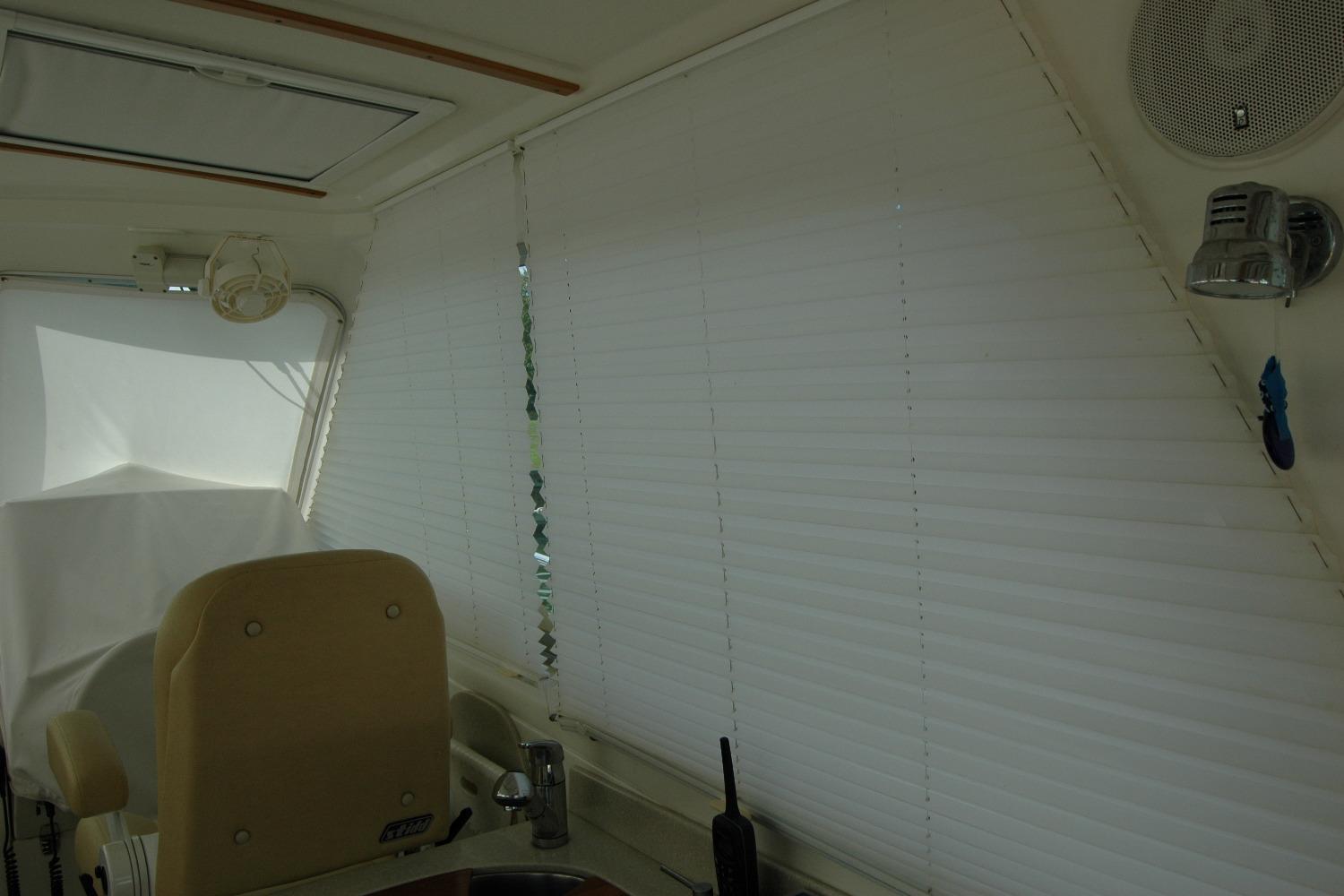 Interior of 2014 Back Cove 34 boat with blinds and seating.