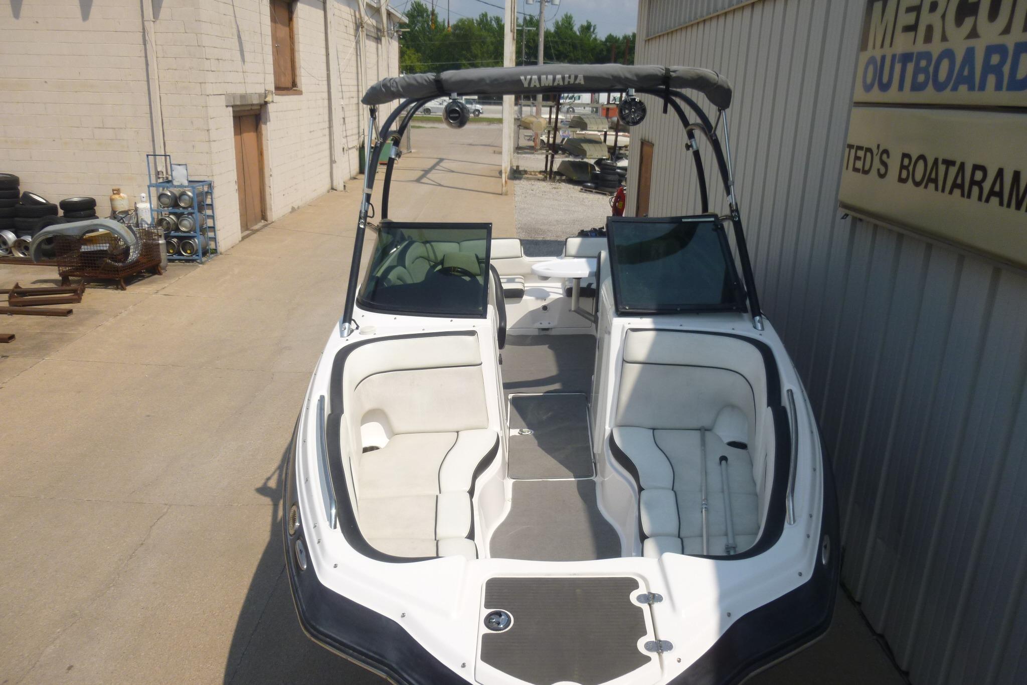 2014 Yamaha Boats 240, white interior, parked at a marina.