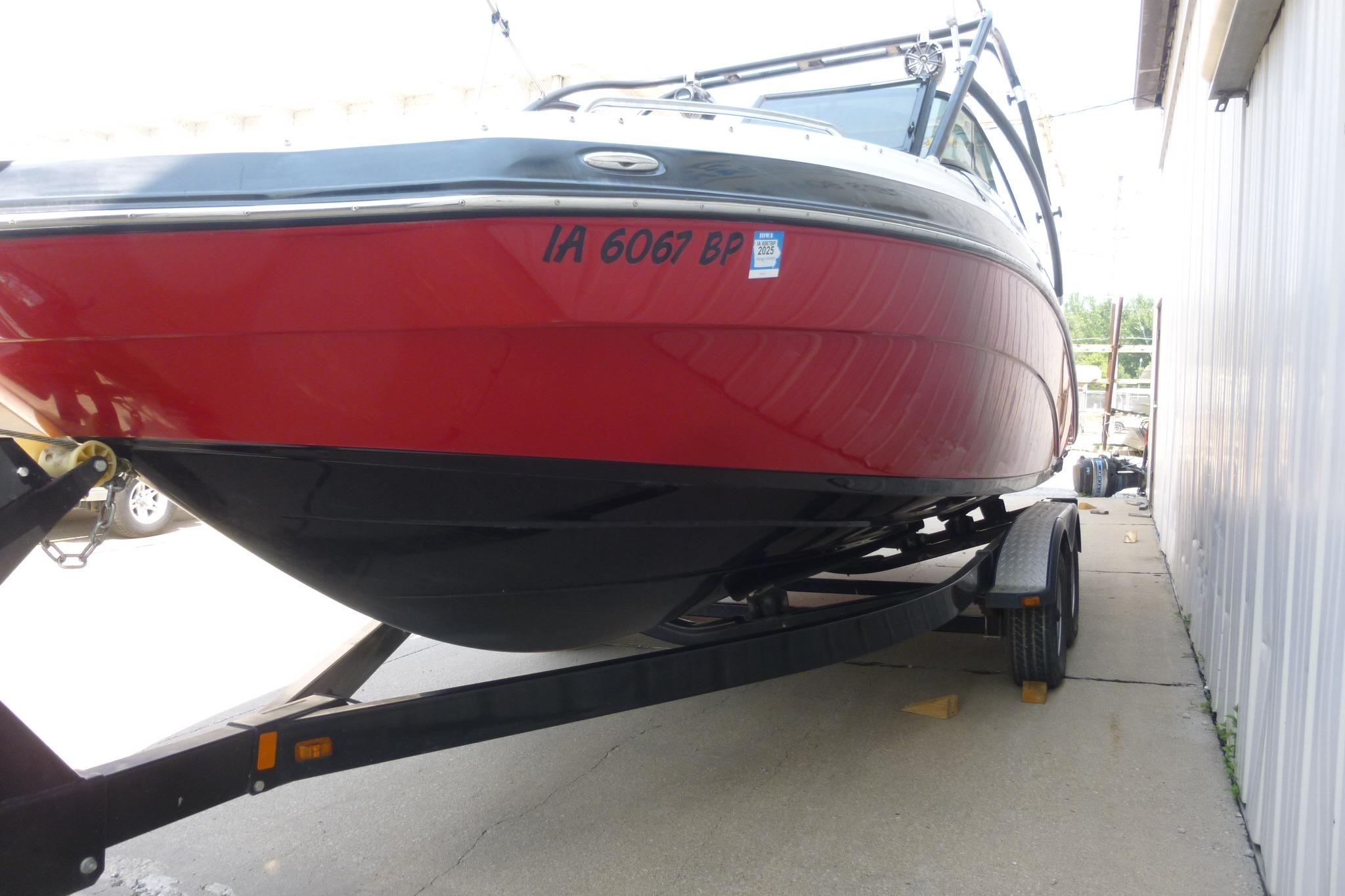2014 Yamaha Boats 240, red and black, on trailer, parked outdoors.