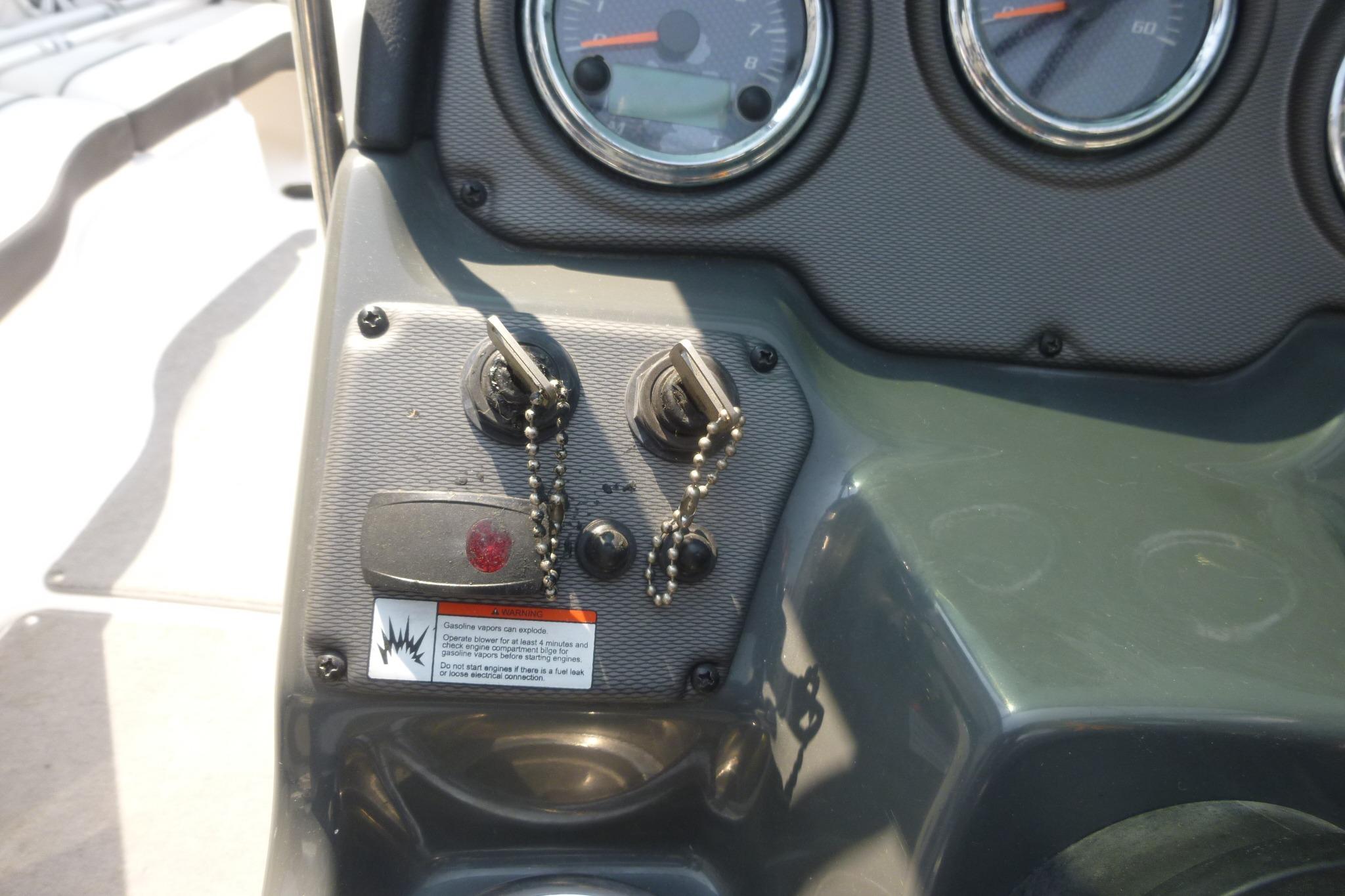 Dashboard of a 2014 Yamaha Boats 240 with ignition switches and gauges.