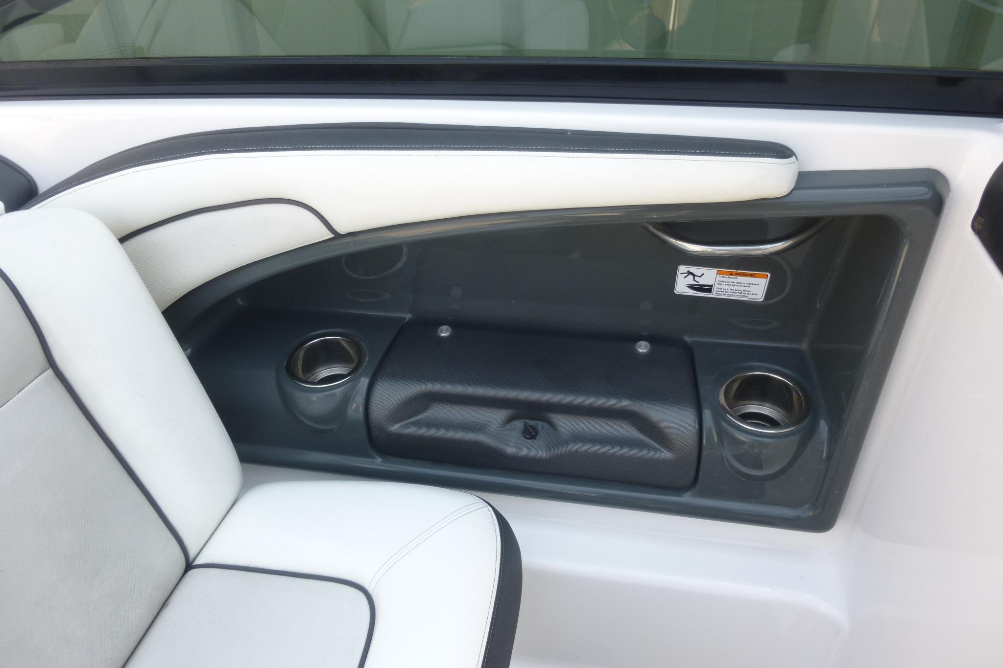 Interior of 2014 Yamaha Boats 240, featuring white seating and cup holders.