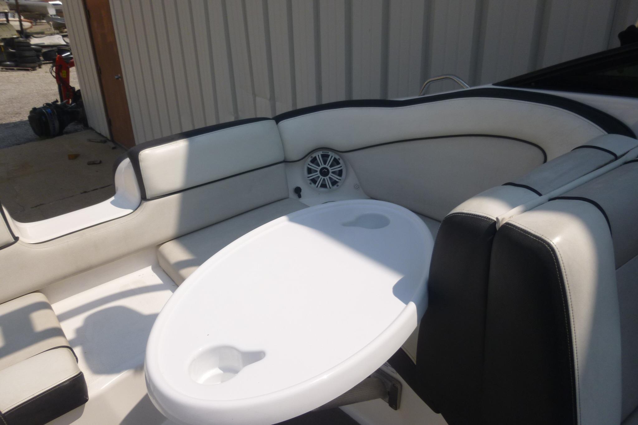 2014 Yamaha Boats 240 interior with white seating and oval table.