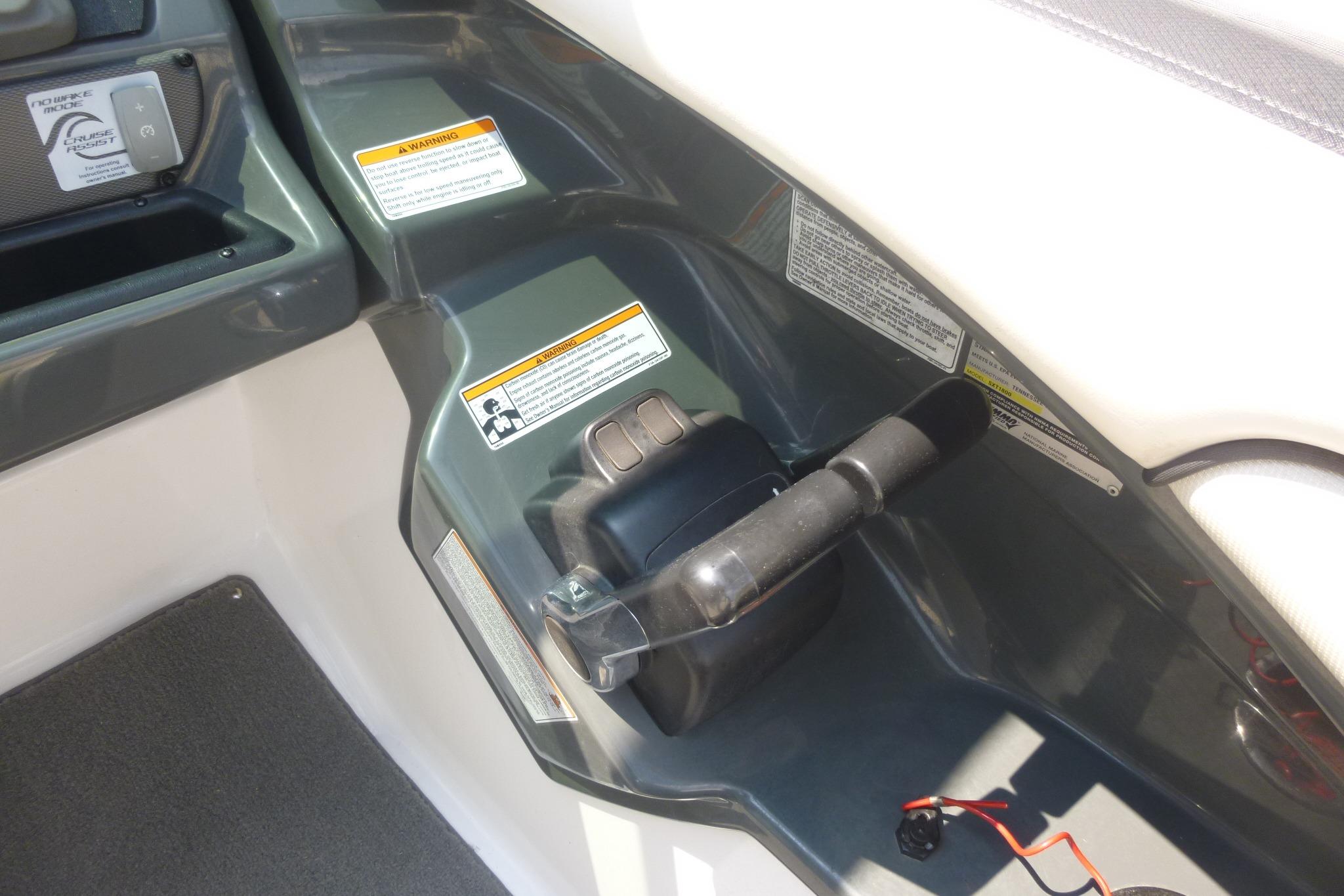 Control panel of a 2014 Yamaha Boats 240, featuring throttle and warning labels.