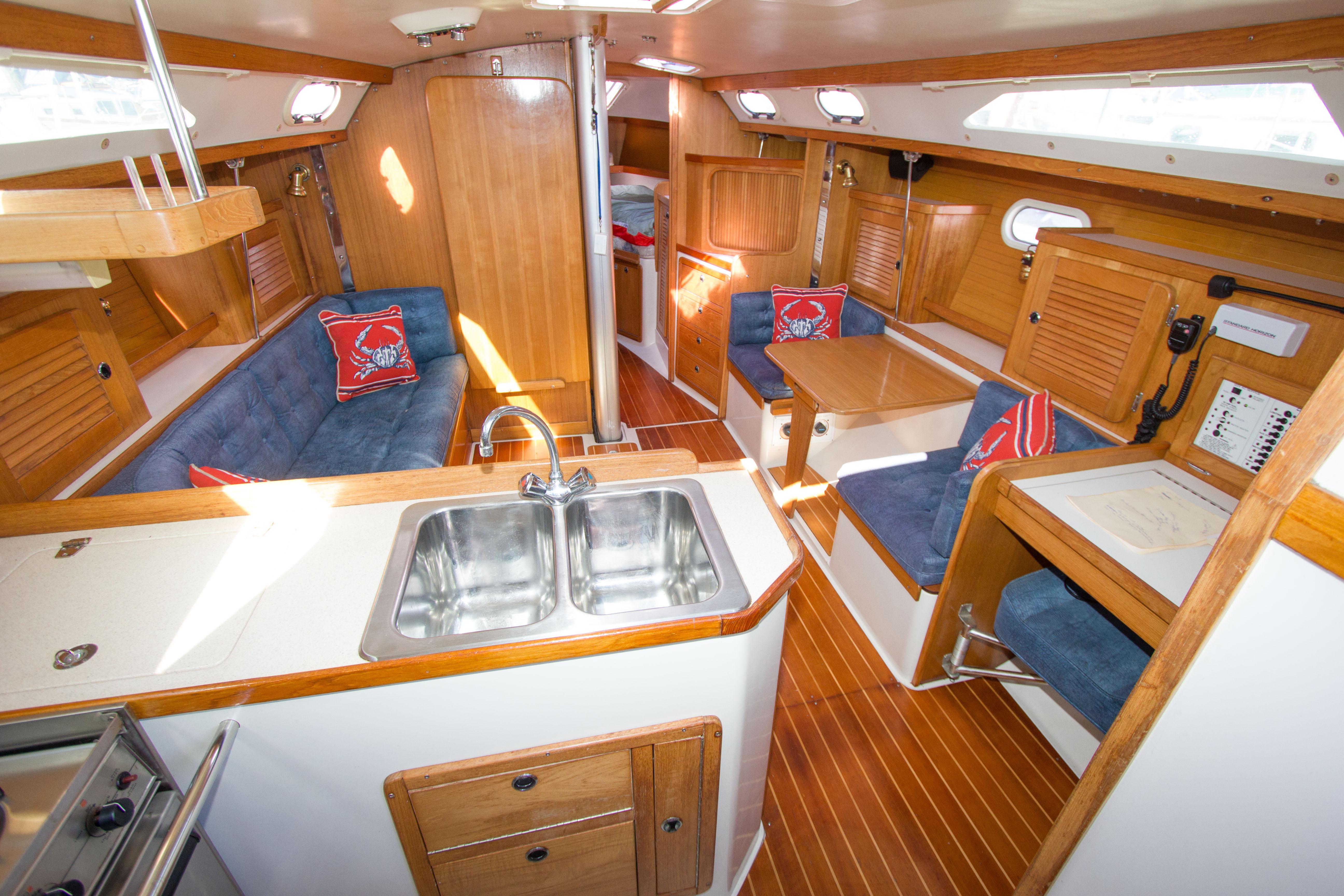 Interior of 2001 Catalina MK II sailboat with wood finish and blue seating.